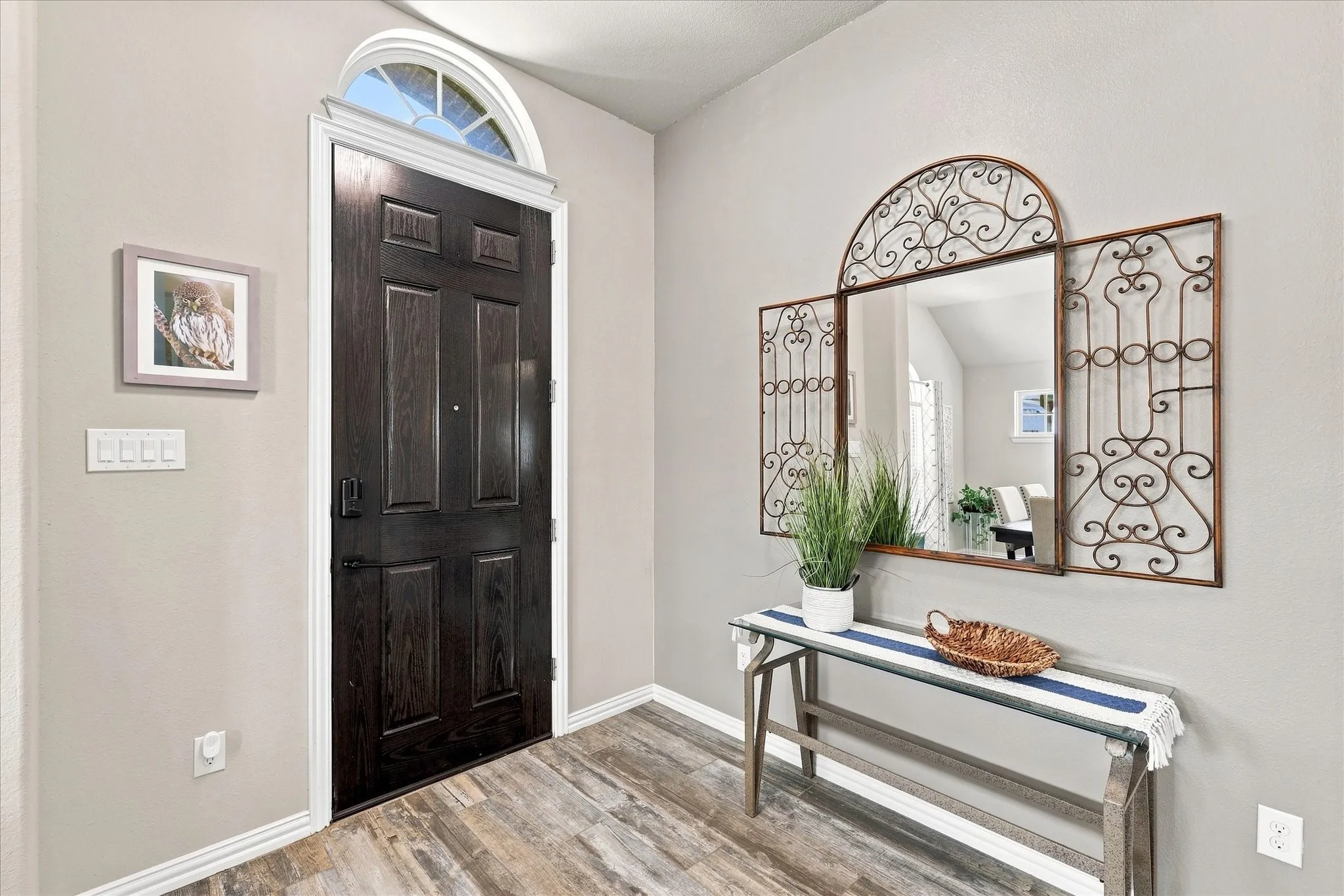 Inviting Formal Entry onto Upgraded Wood Look Flooring that Extends throughout the Main Floor of this Light and Open Floor Plan.
