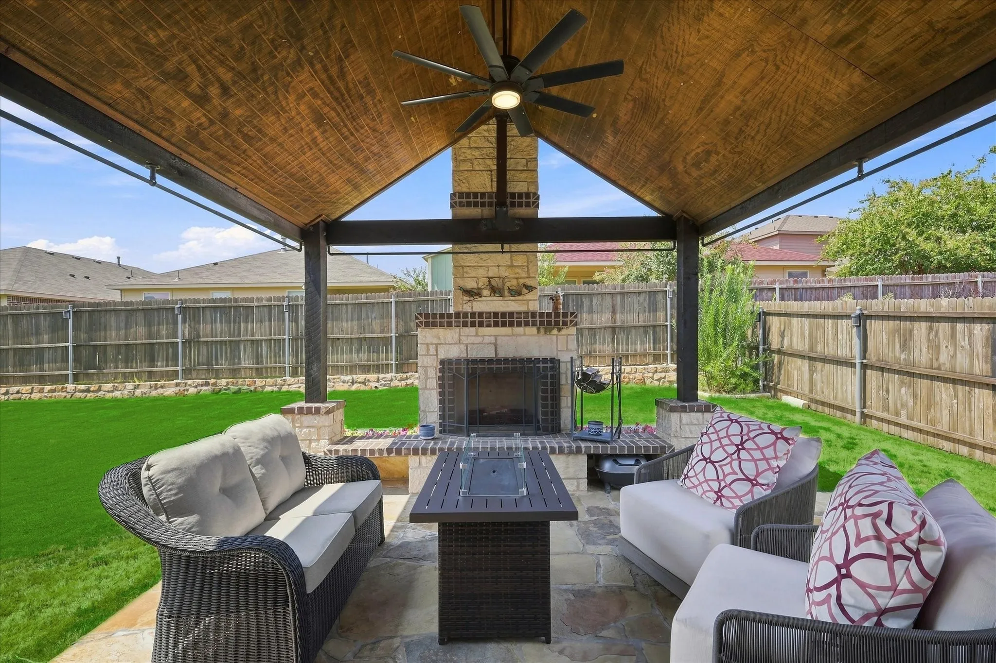 Impressive Outdoor Living Area features an Expansive Covered Flagstone Patio, Wood-plank Vaulted Ceiling, Exposed Beams, Lighted Ceiling Fan, Outdoor Heater. A Dramatic Floor-to-Ceiling Stone Wood Burning Fireplace Anchors the Space, while the Extended Patio and Large Fenced Backyard provide Plenty of Room for Dining, Grilling and Entertaining.