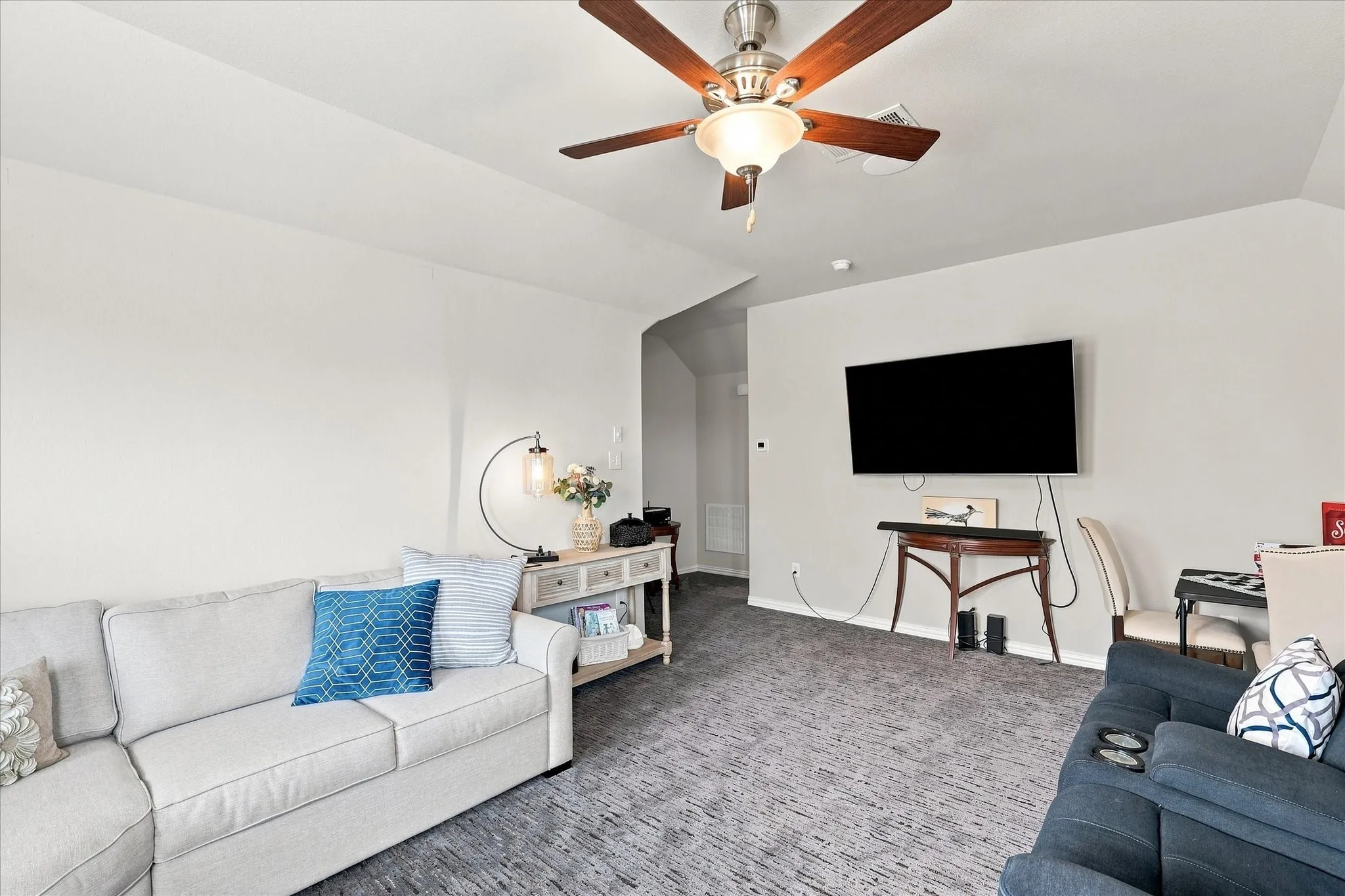 Spacious 2nd-Floor Bonus Room features a Vaulted Ceiling, Lighted Ceiling Fan, Abundant Natural Light. A Generous Open Space Ideal as a Game Room, Media Room or Family Room. A Versatile Retreat Separate from the Main Living Spaces.