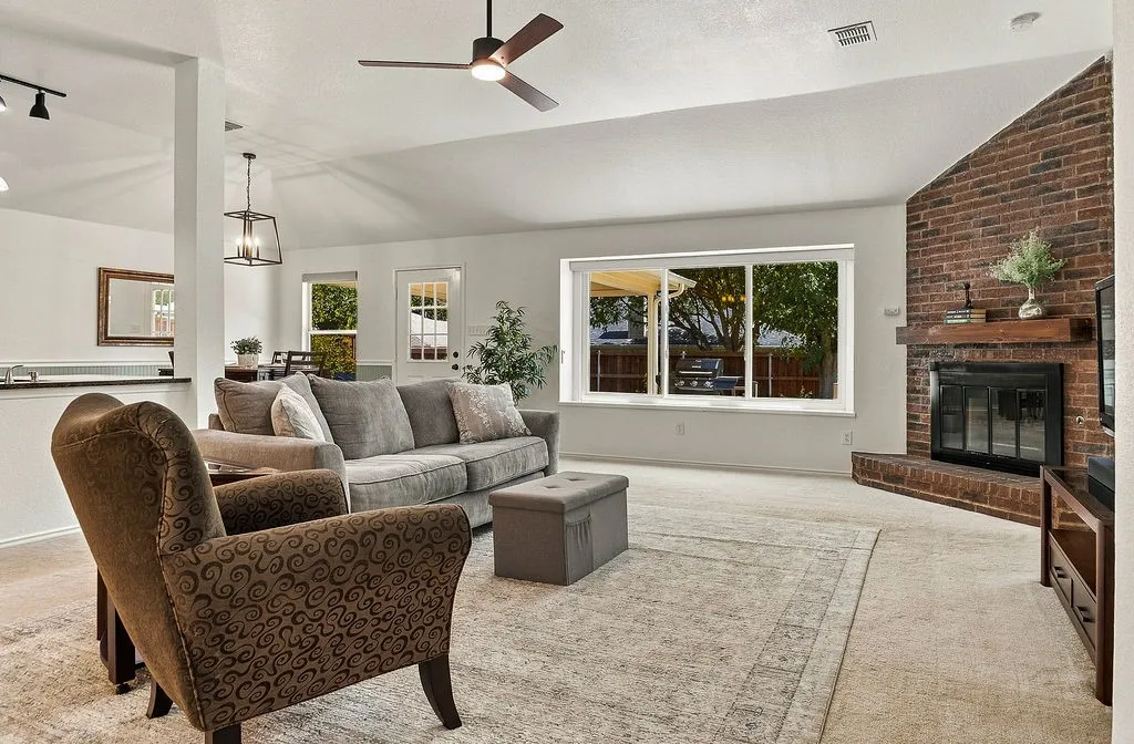 Living room with gas start fireplace and newer windows