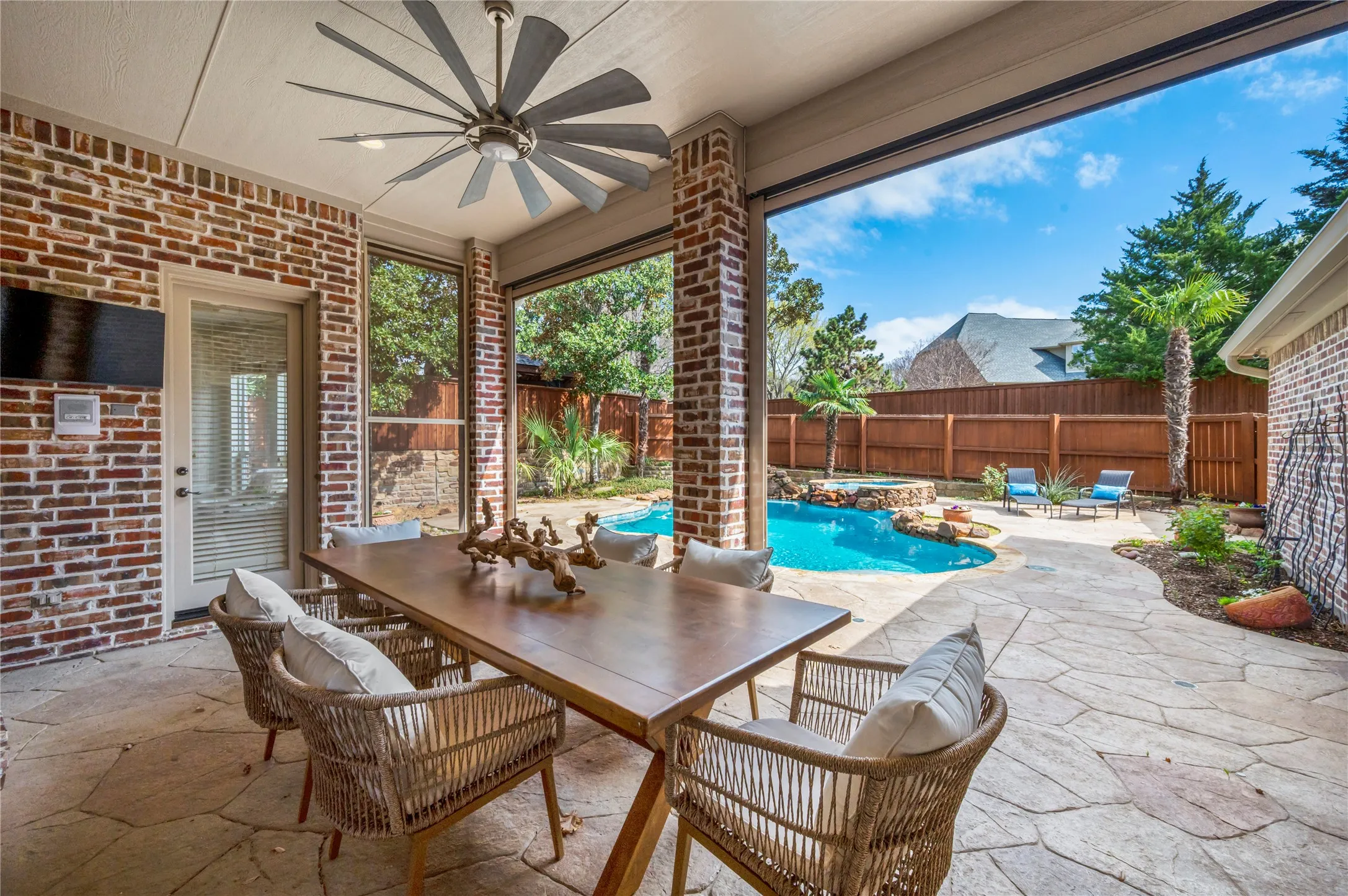 Remote controlled screens adorn the covered patio.