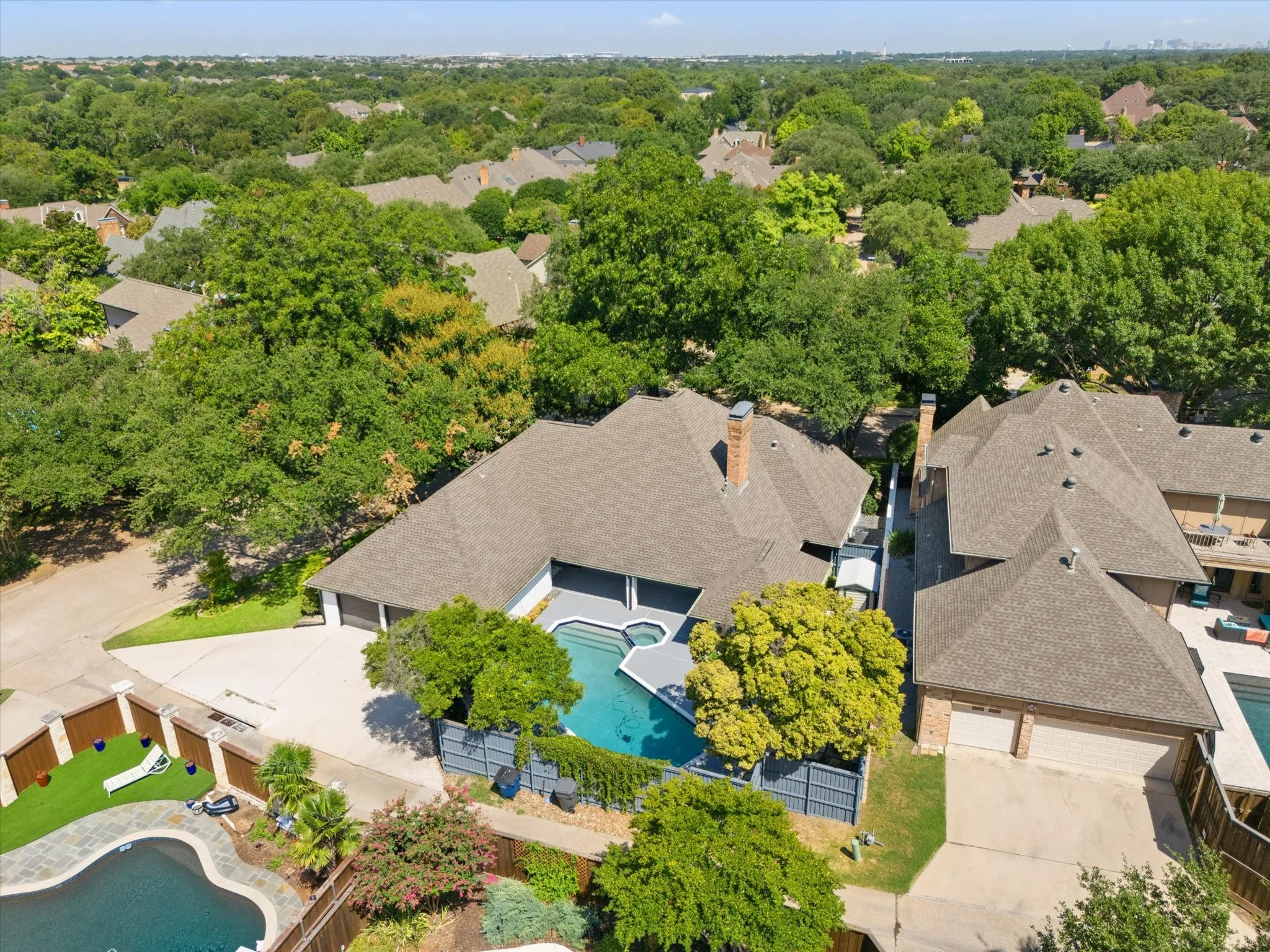 Aerial perspective of suburban area with a pool