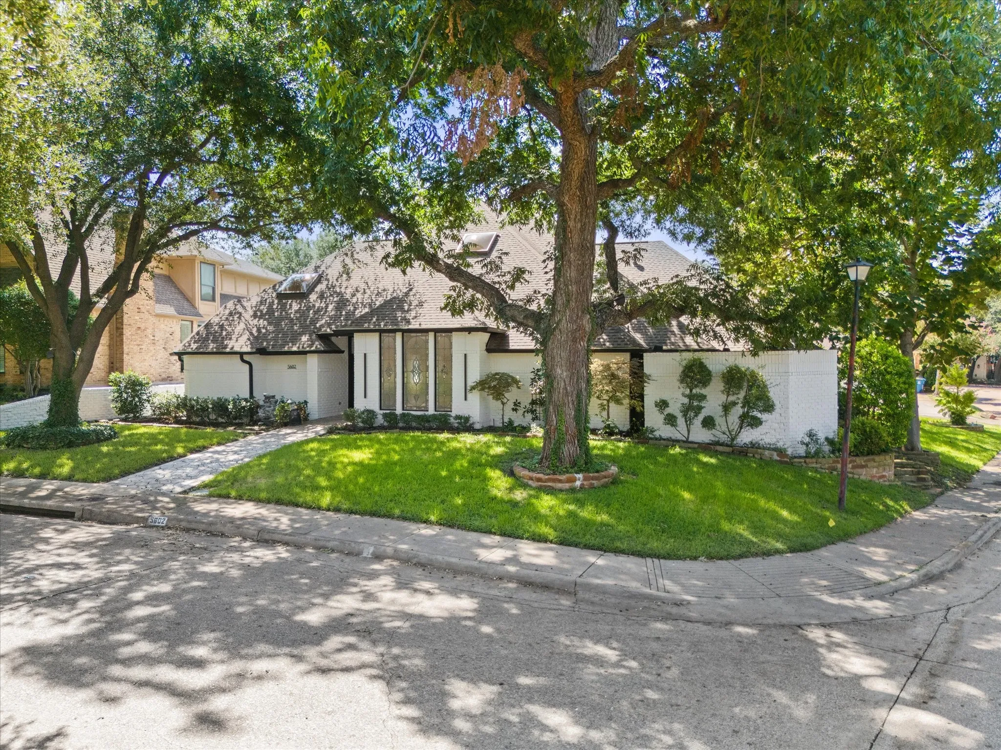 View of front of home with a front lawn and stucco siding