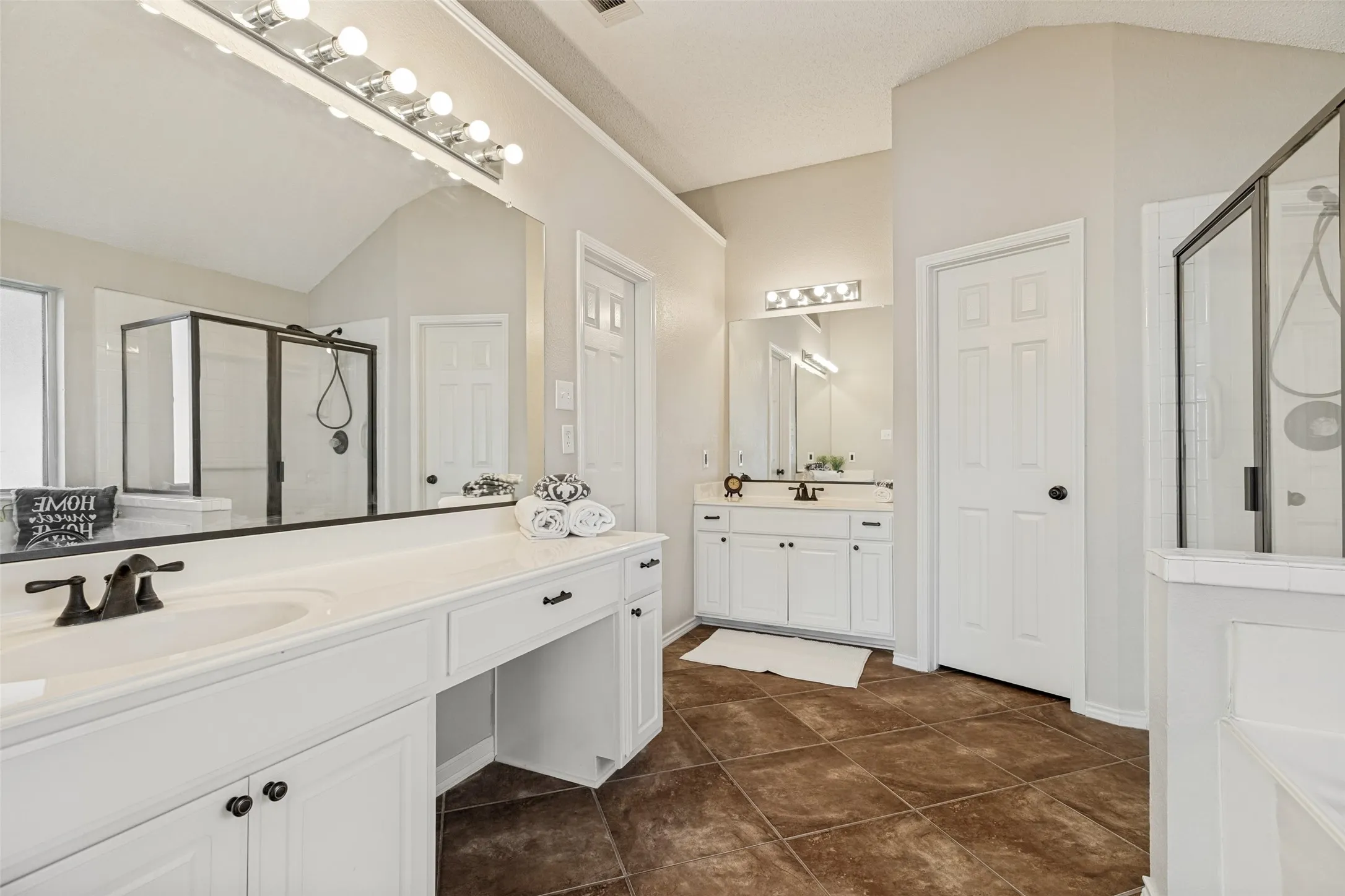 loads of elbow room with two vanities, private water closet
