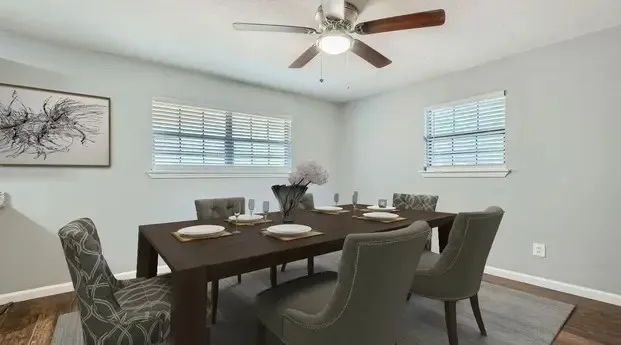 Recessed windows with blinds, wood-finish flooring, ceiling fan with light fixture, and light-toned wall paint