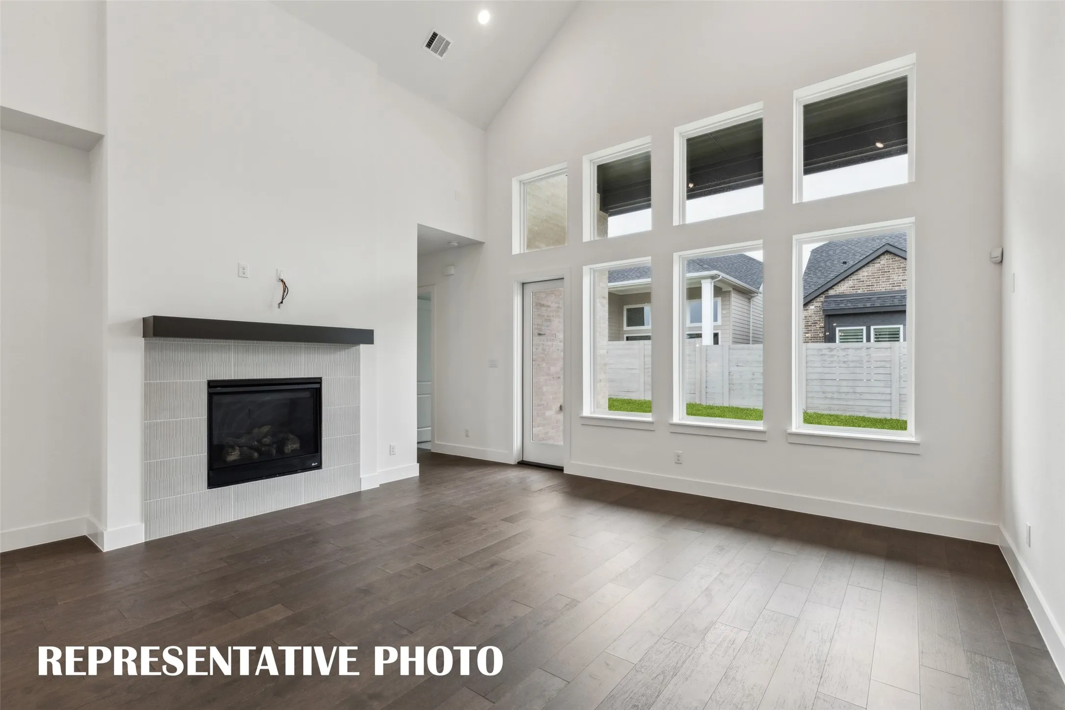 A wall of windows floods this wonderful family room with natural light!  REPRESENTATIVE PHOTO