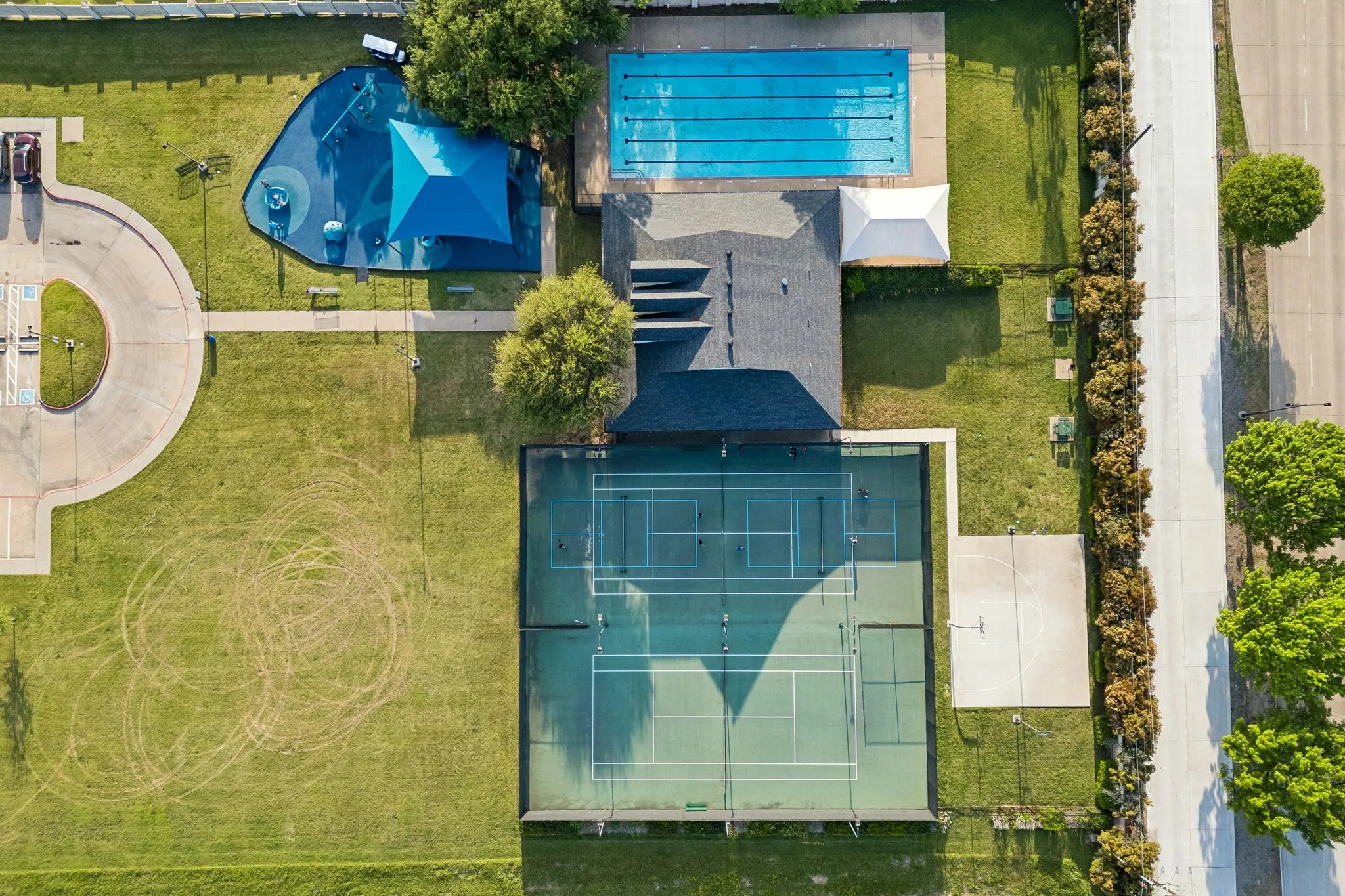 HOA community center featuring, pool, playground, tennis court, basketball court and pickleball court.