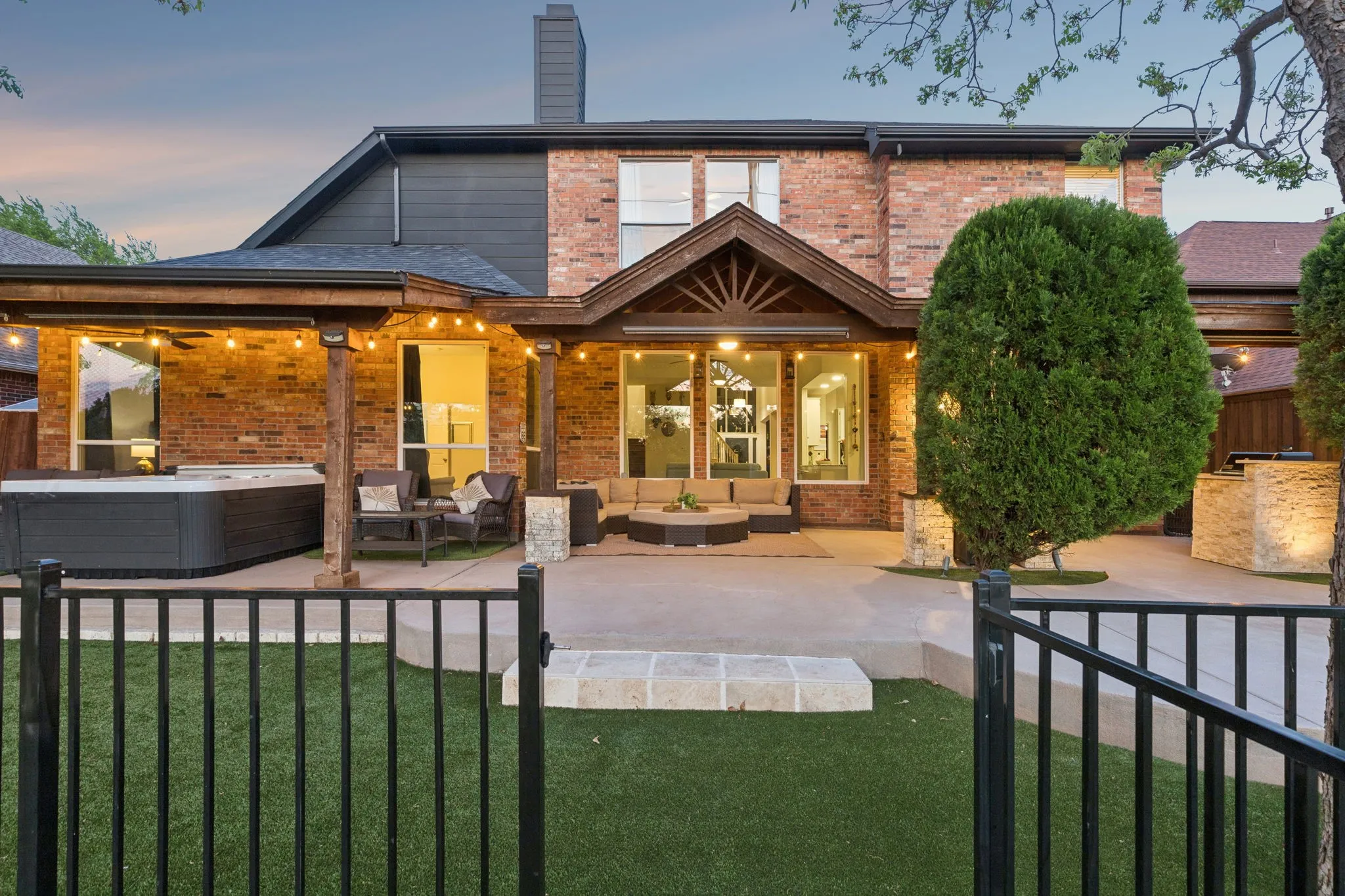 View from the golf course of the concrete deck, iron fence and cedar wood coverage.