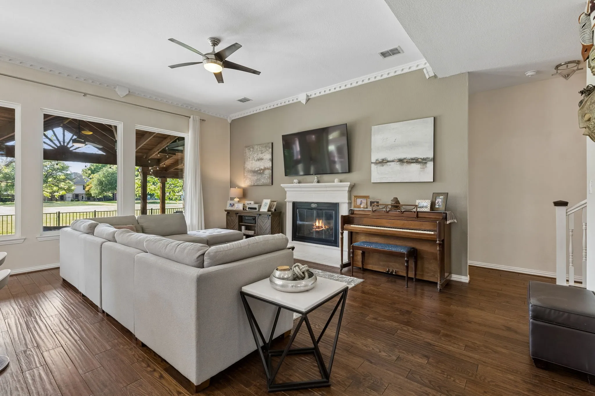 Featuring portrait windows, fireplace and ceiling fan.