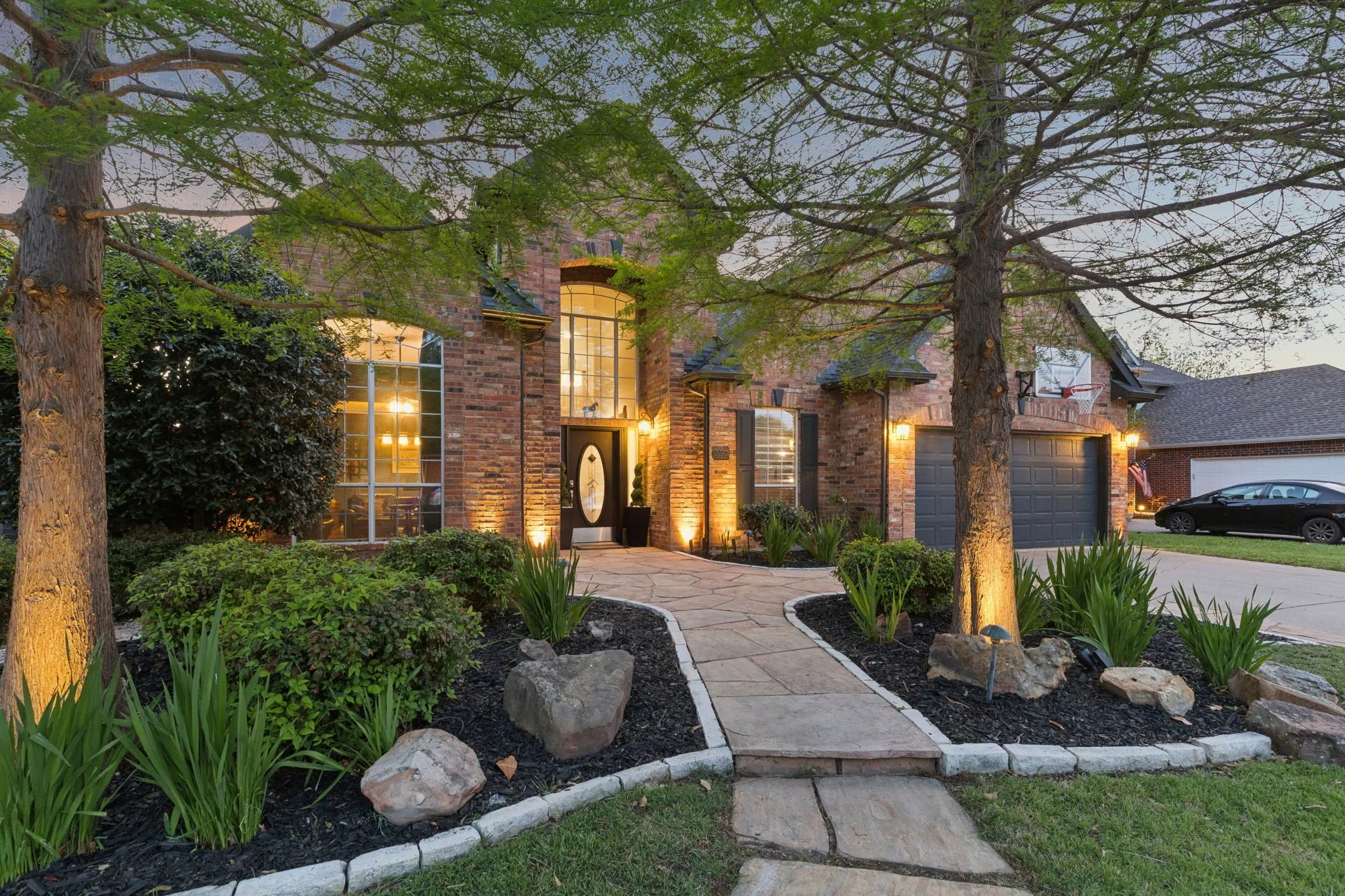Featuring landscape lights and stamped concrete.