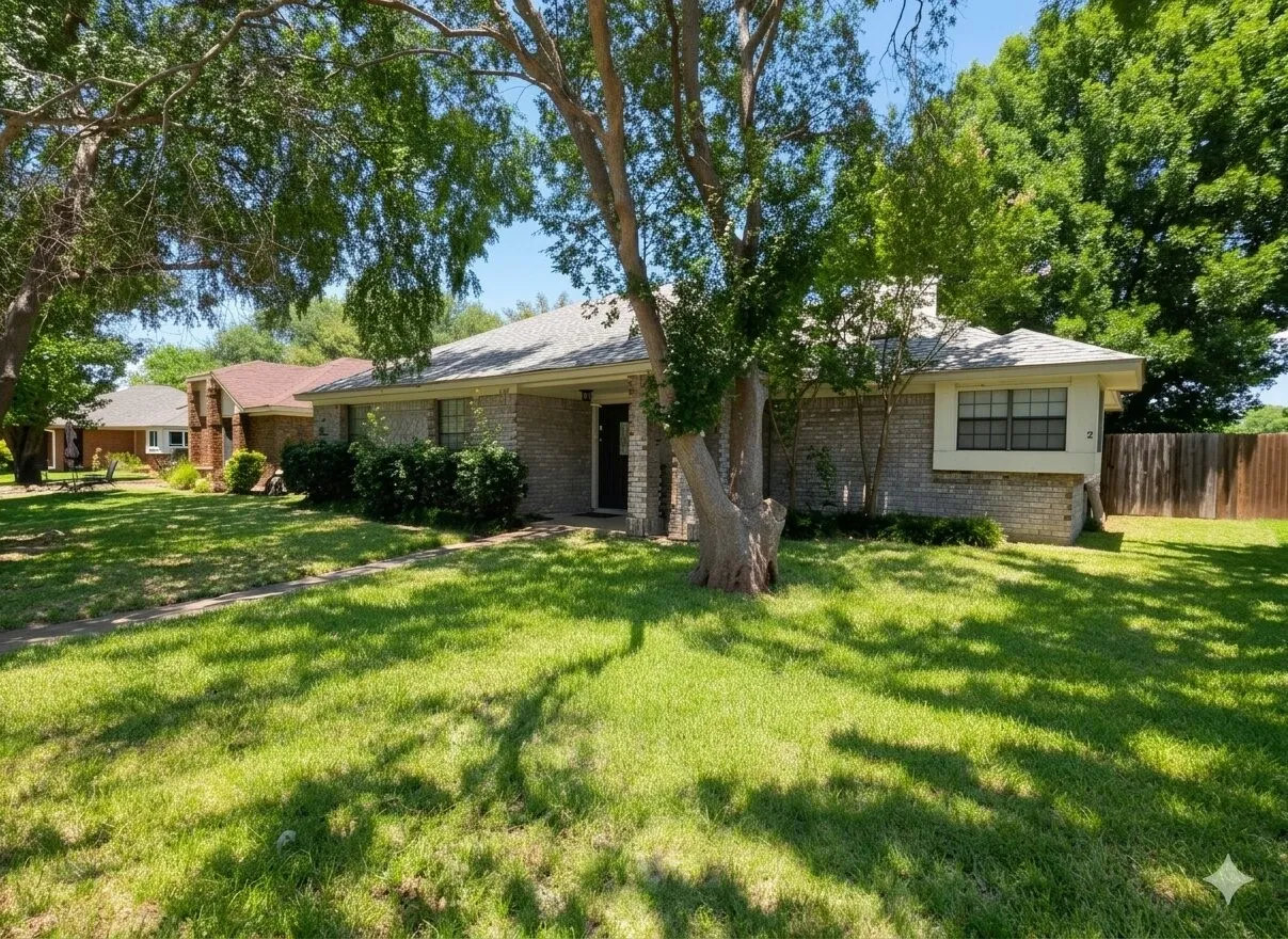 Single-story residence featuring a brick exterior, a shingle roof, and a mature tree in the front yard
