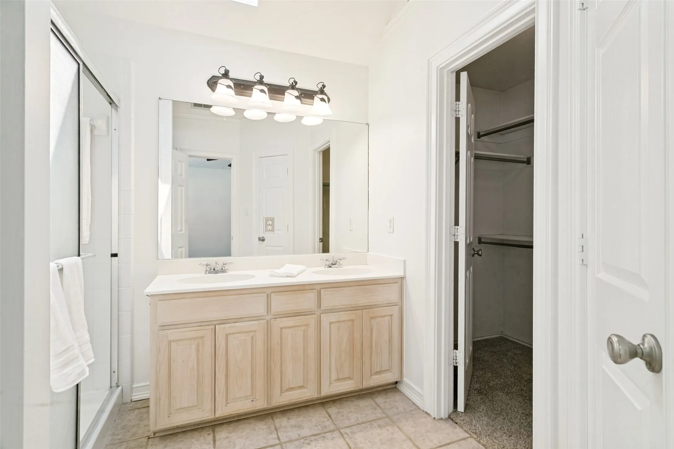 Primary bath with fresh paint and walk-in closet.