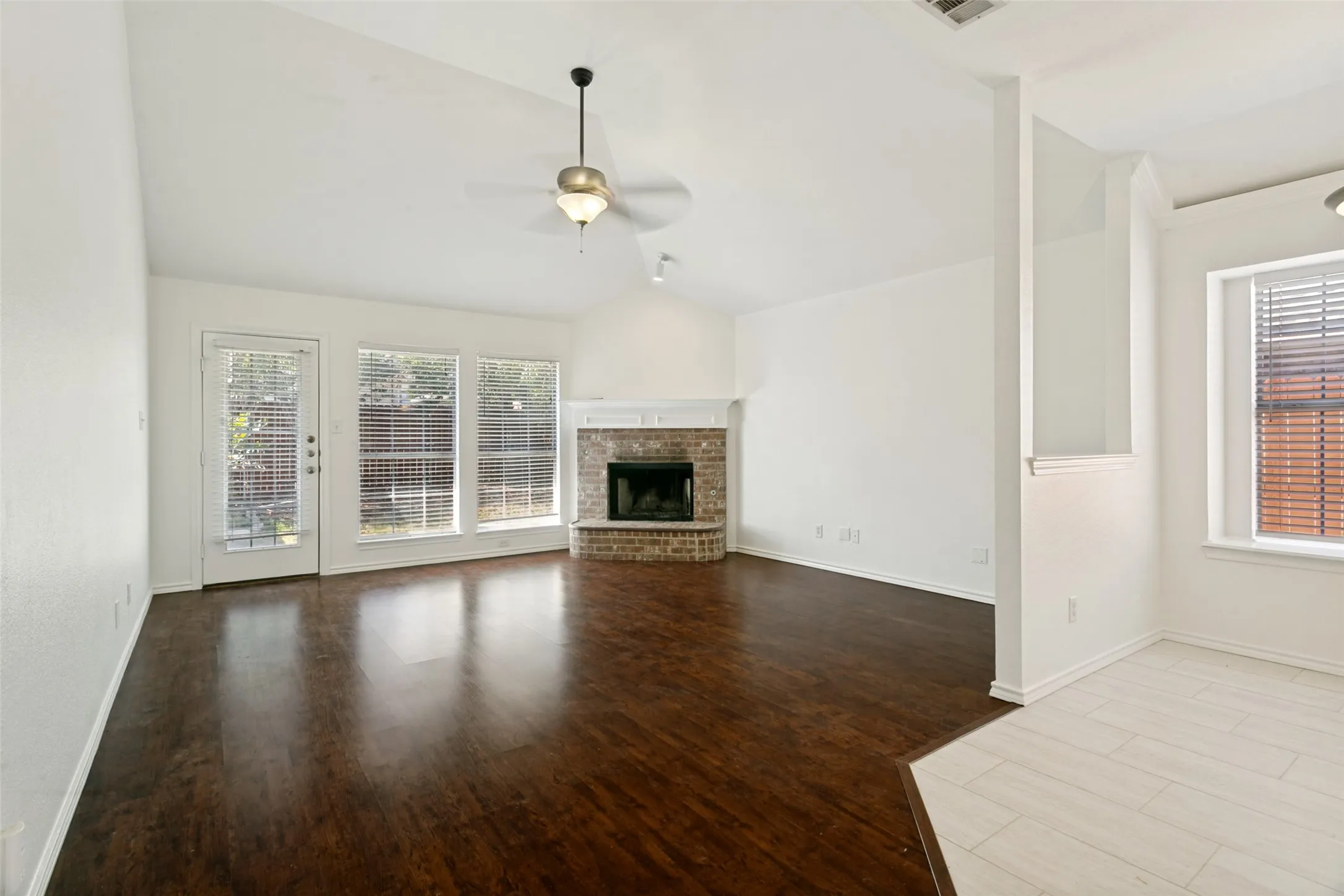Living area open to the kitchen with a cozy gas fireplace.