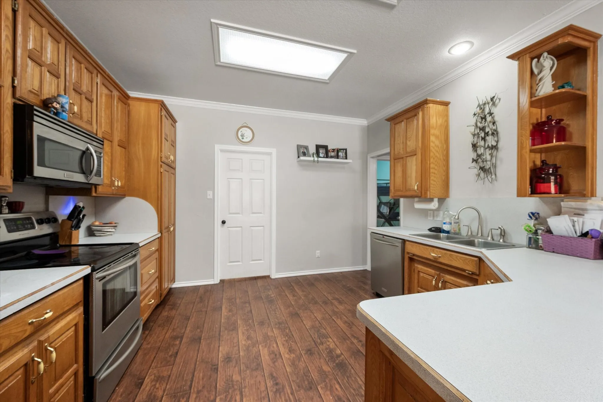 Kitchen featuring wood-finish flooring, recessed lighting, and a skylight