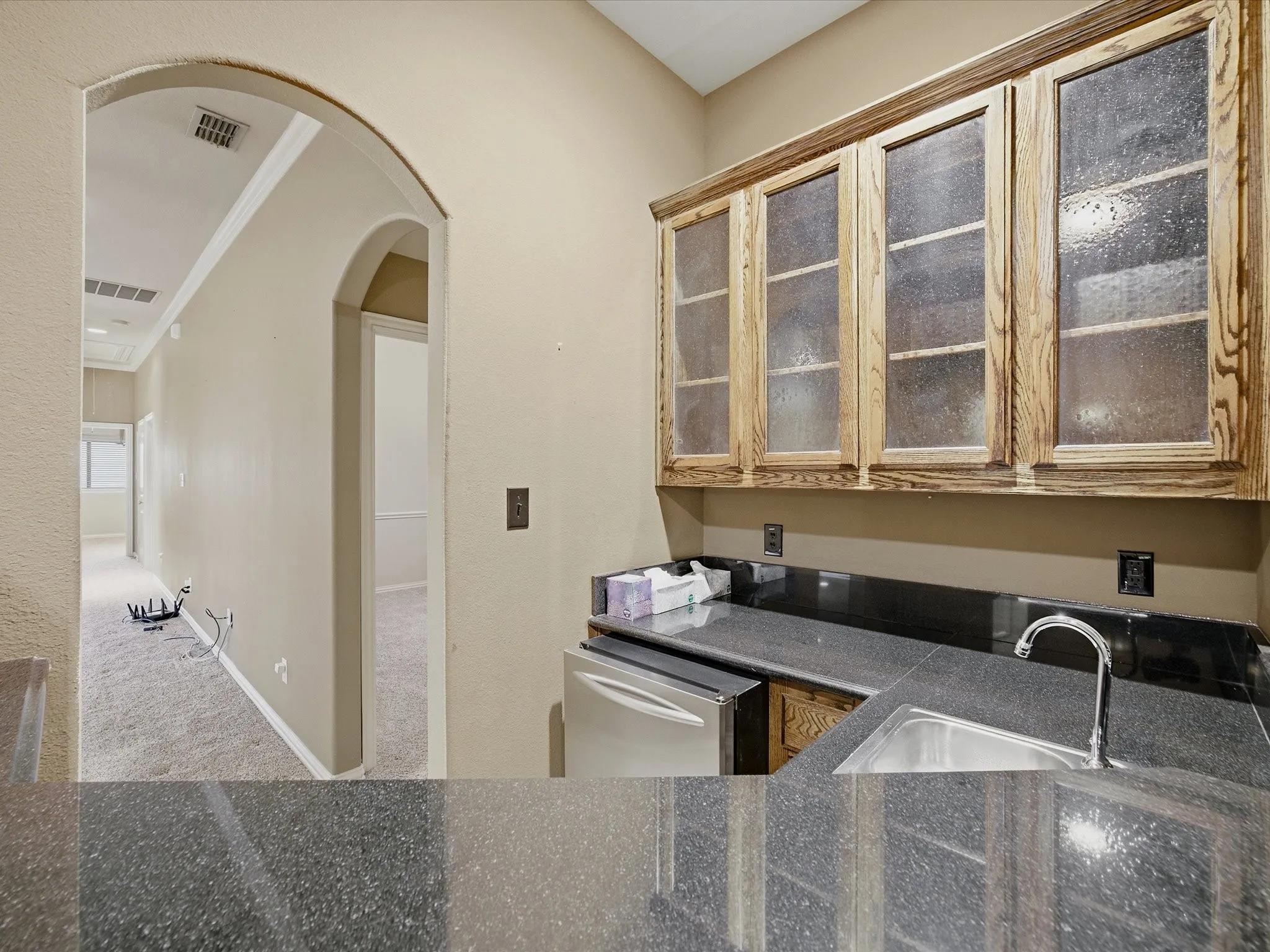 Wet bar in Game Room leading to Media Room