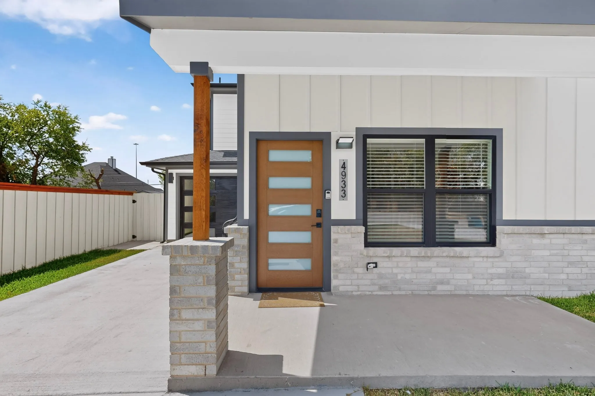Modern exterior with vertical siding and light-toned brickwork