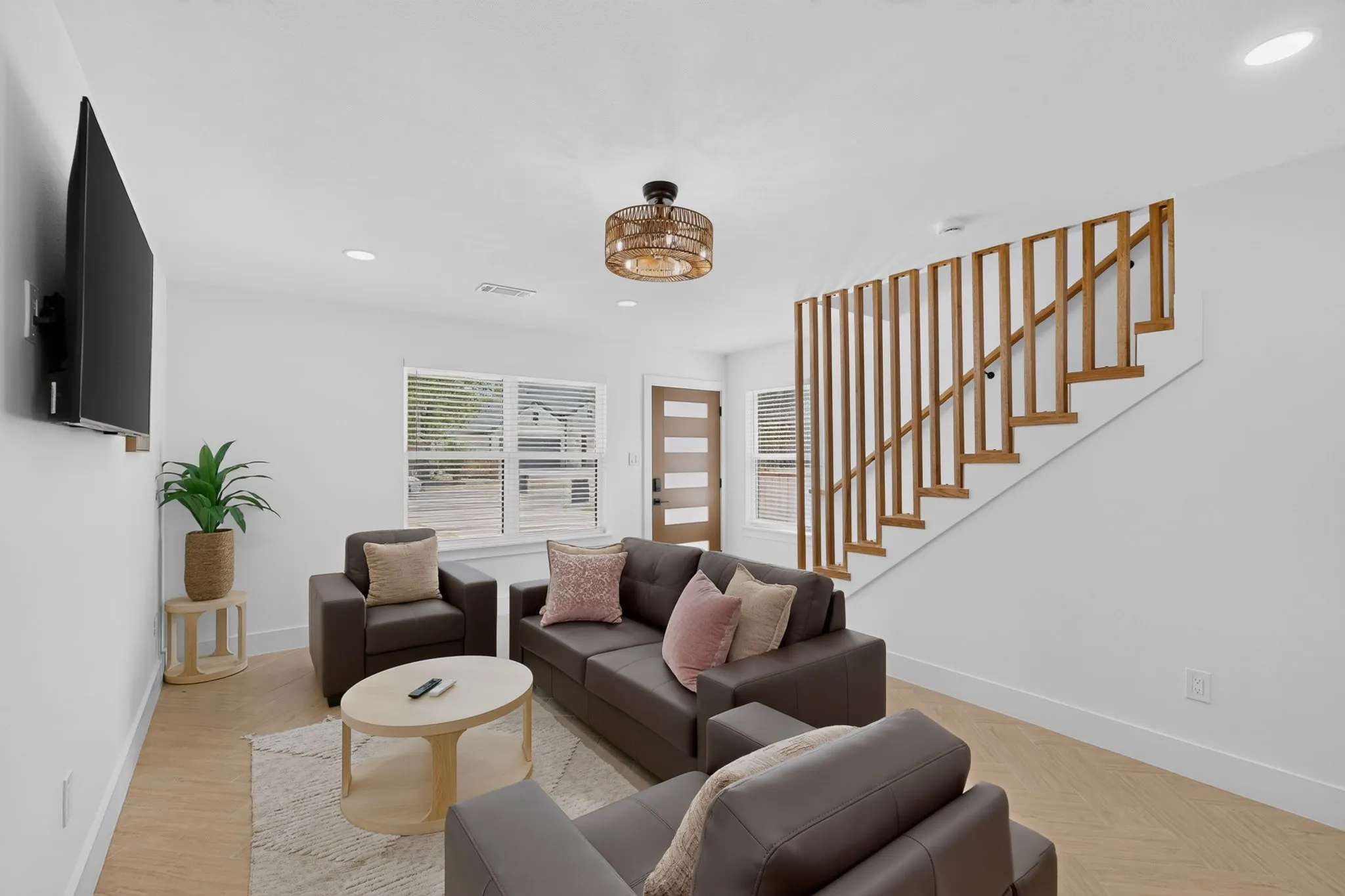 Wood-finish flooring, recessed lighting, and a contemporary wooden slatted staircase railing