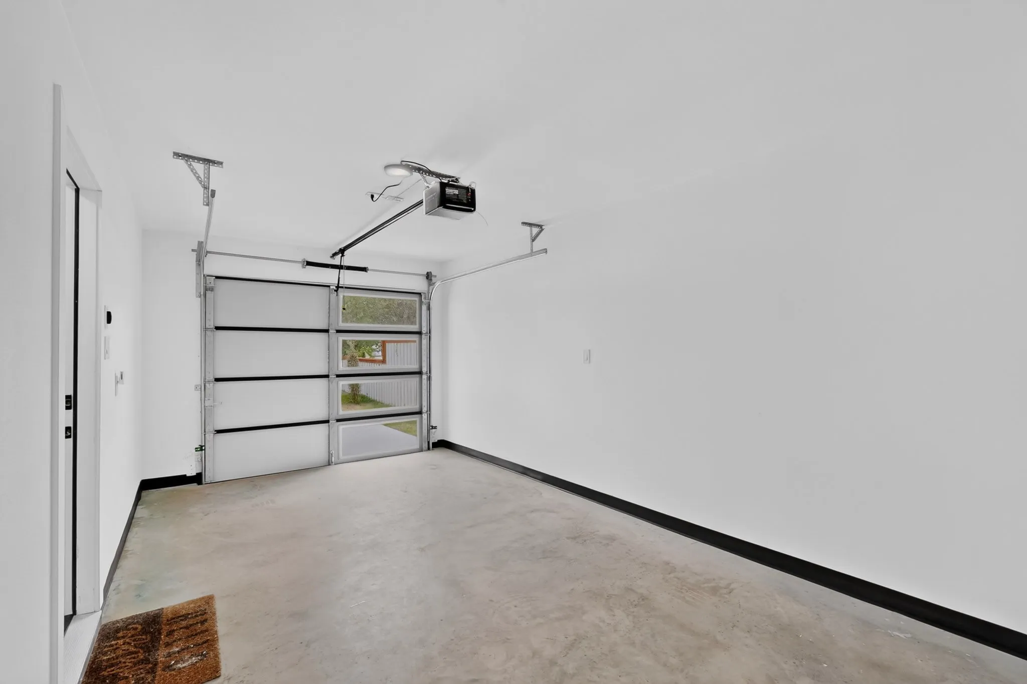 Concrete flooring and white walls in garage space