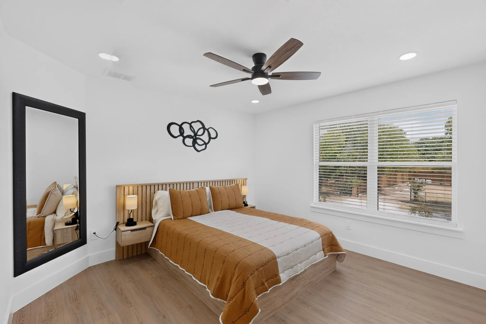 Wood-finish flooring, recessed lighting, and a ceiling fan with light fixture