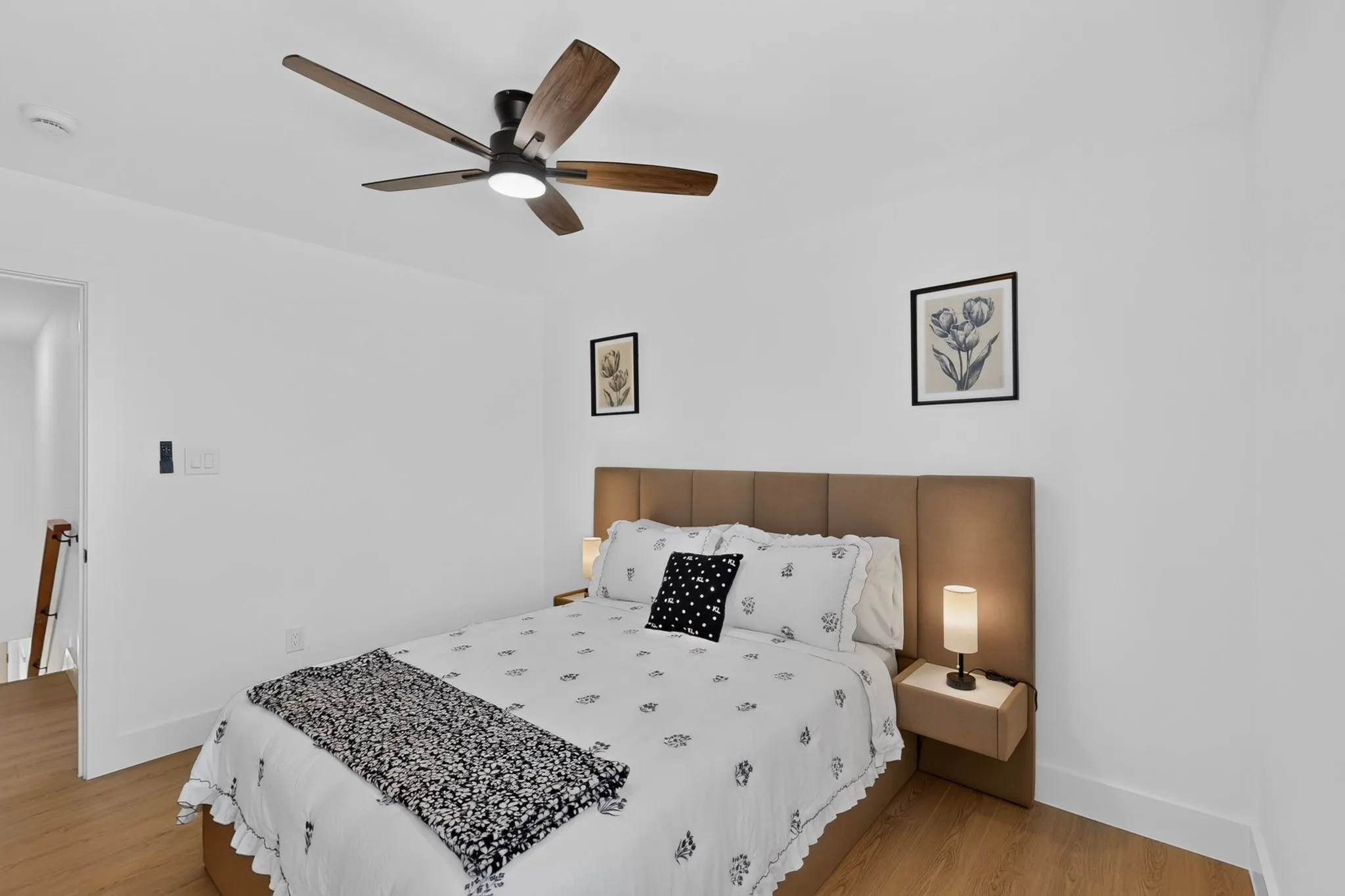 Wood-finish flooring, recessed lighting, and a five-blade ceiling fan with integrated illumination