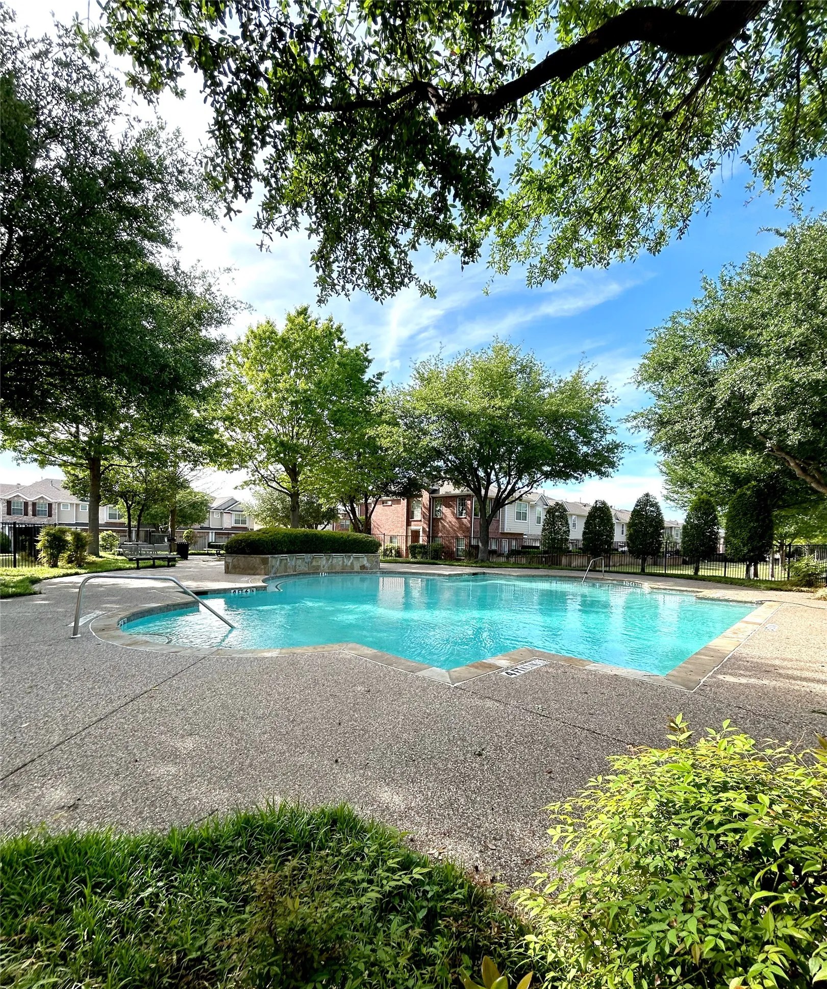 View of community swimming pool featuring a patio area