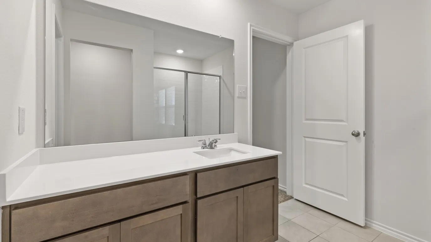 White countertop with an integrated sink and chrome faucet