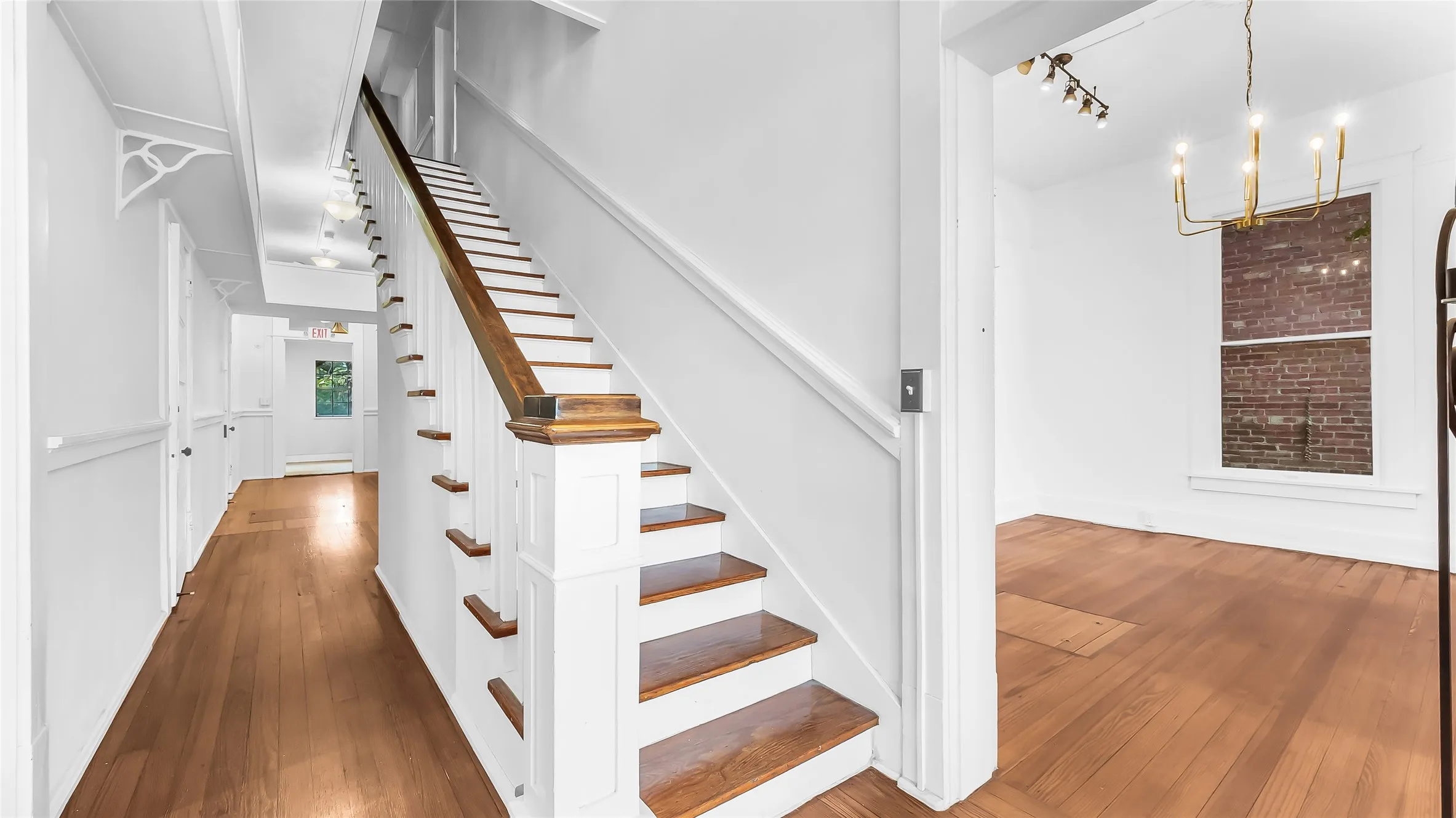 Hardwood flooring throughout the hallway and living area