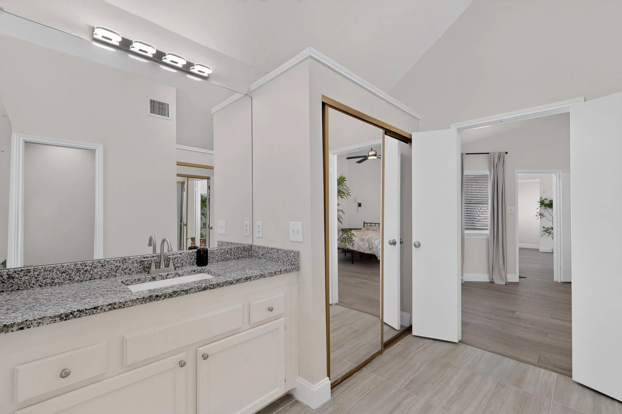 Vanity with speckled countertop and under-mount sink