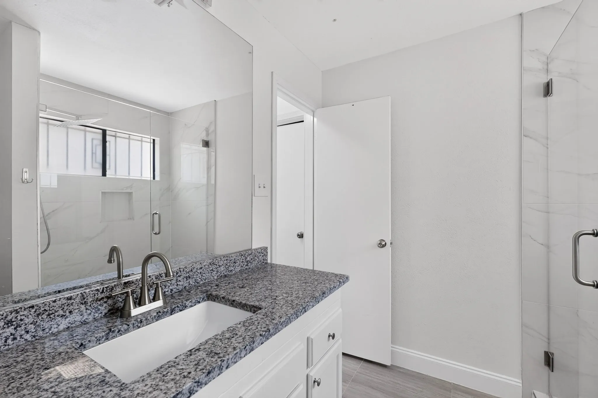 Vanity with a speckled countertop and an undermount sink