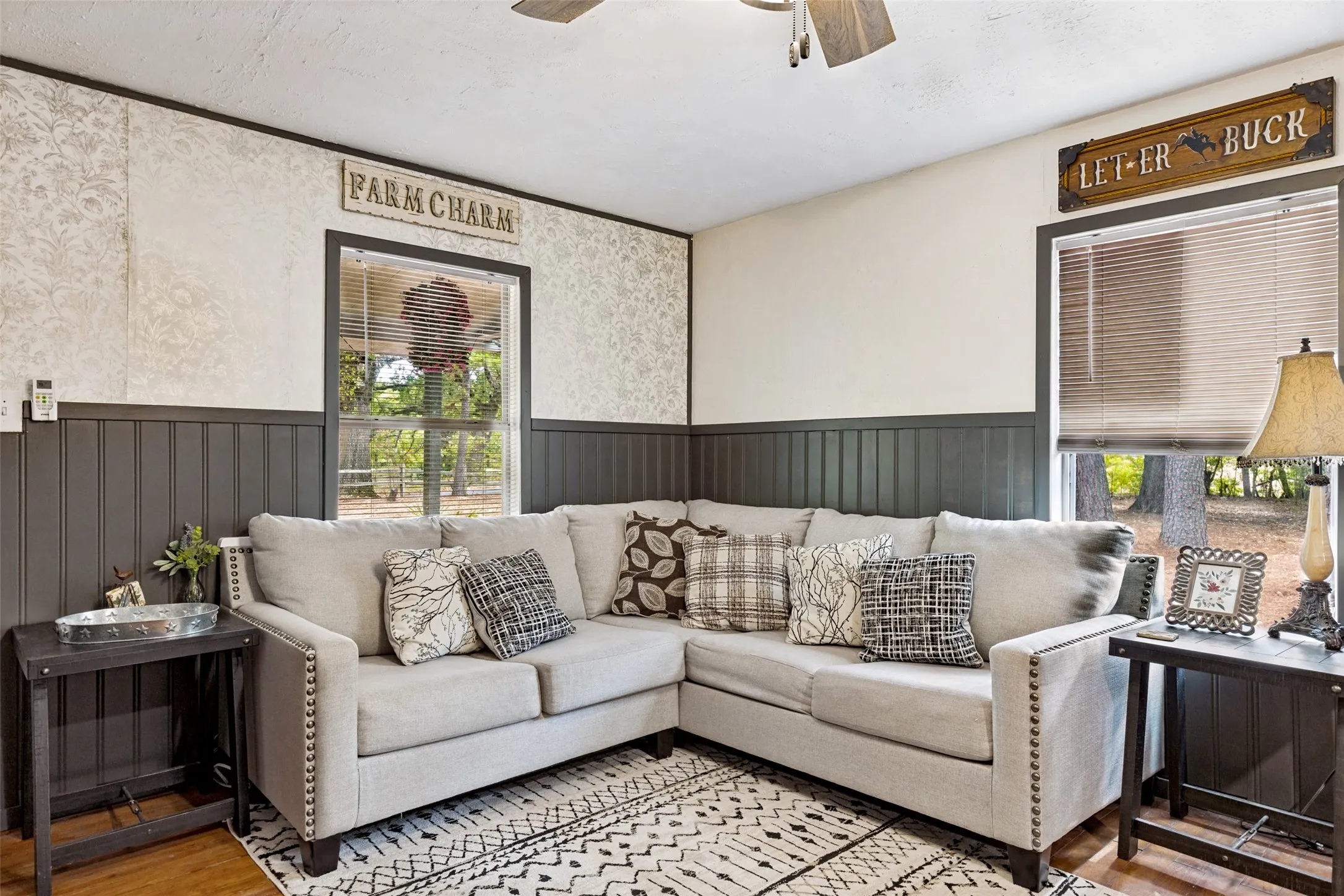 Wood-finish flooring with an area rug, and board and batten wall paneling