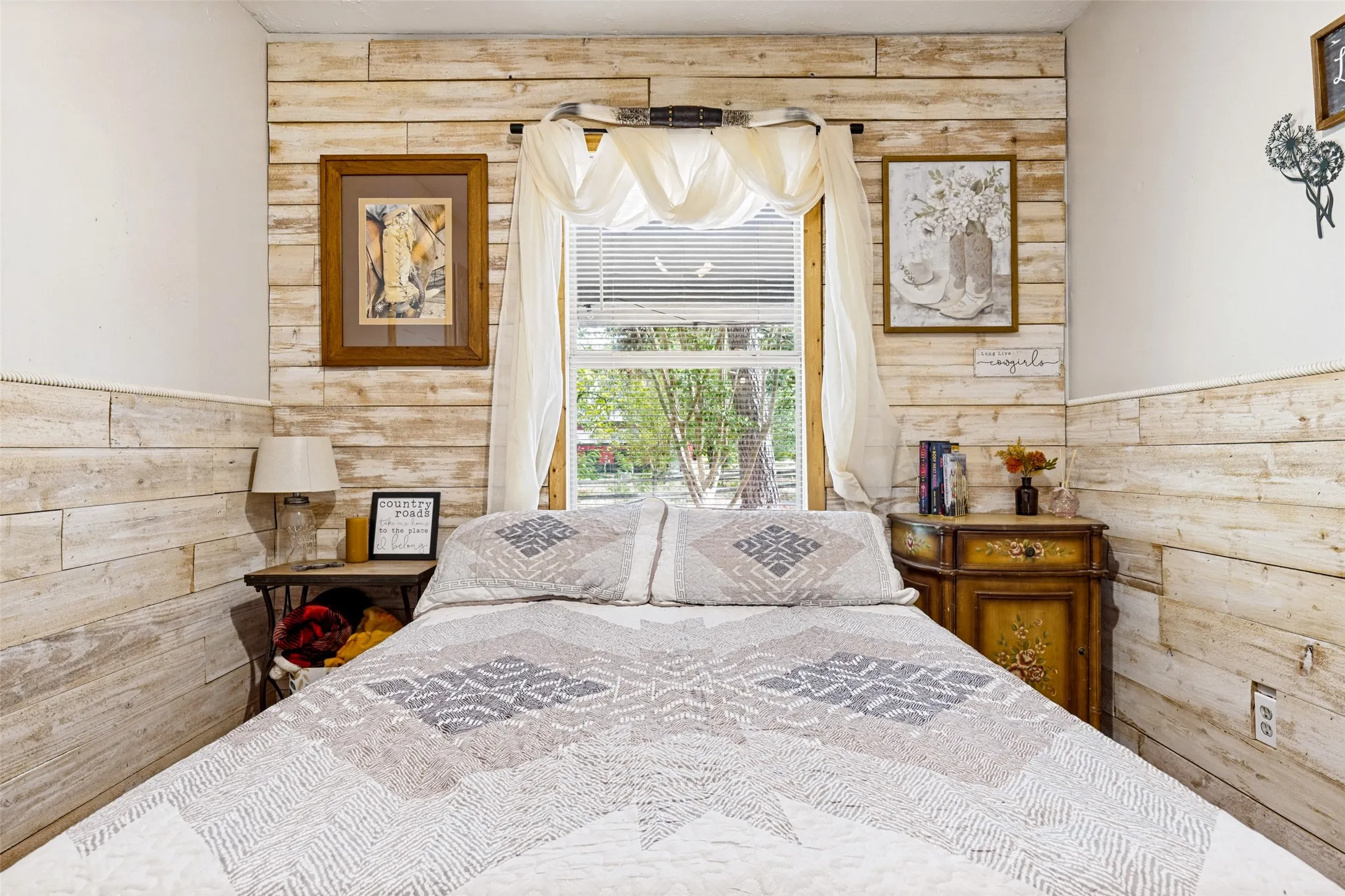Shiplap accent wall with a window featuring blinds