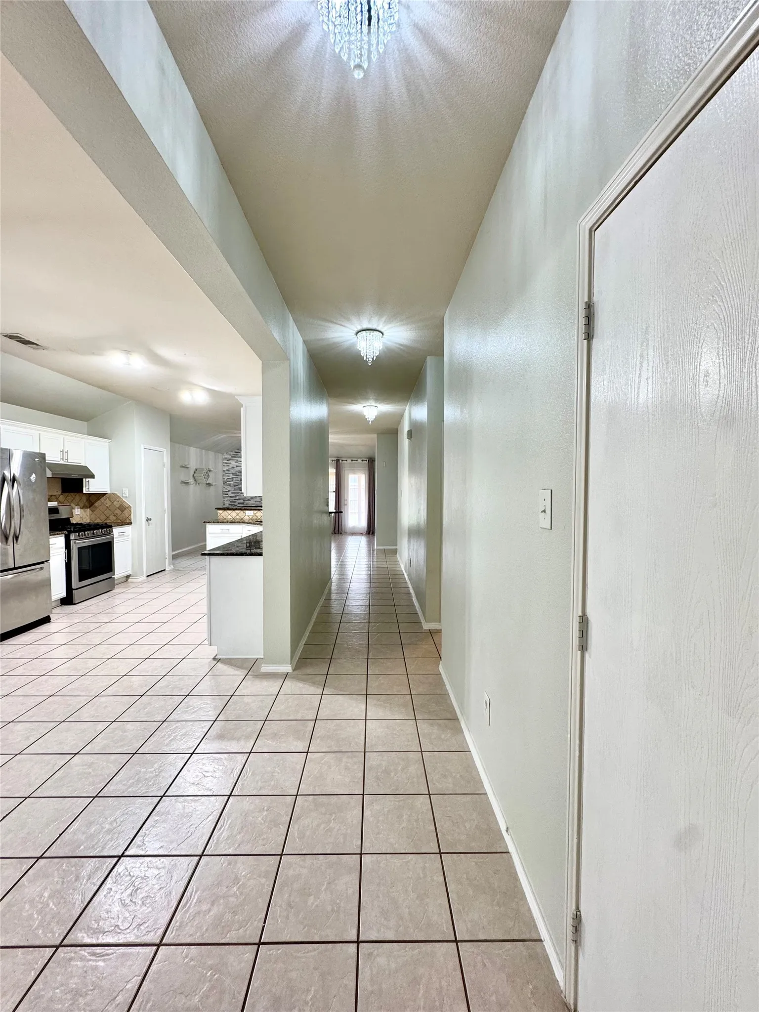 Tile flooring extending through open concept spaces