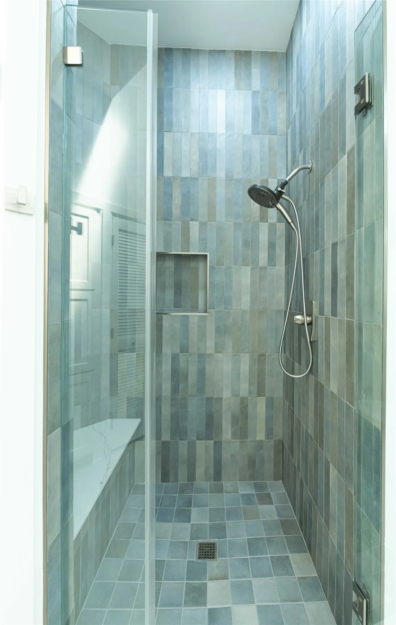 Walk-in shower with sitting area.
