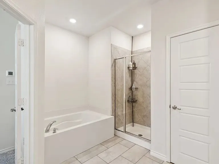 Full bathroom with a stall shower, recessed lighting, and a bath