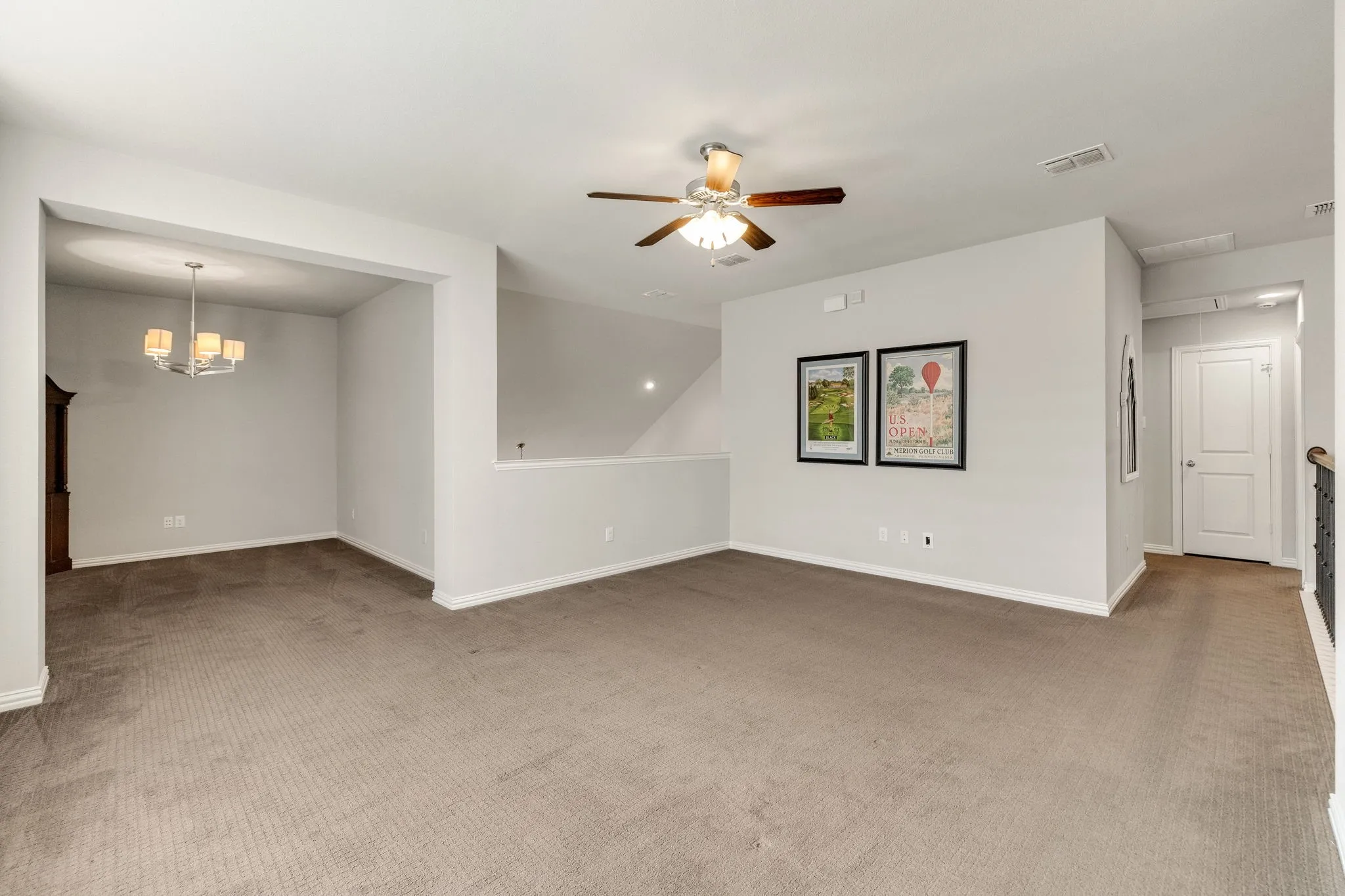 Spacious game room with balcony views of first level.