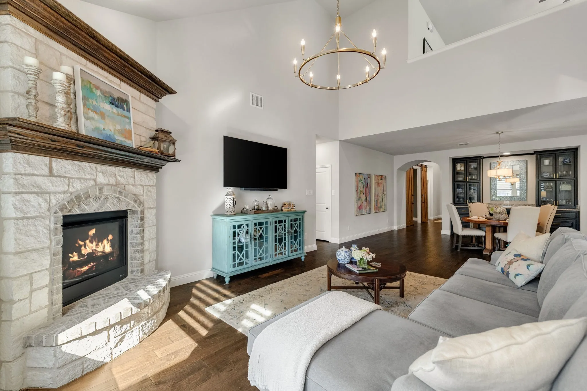 Living room anchored by a stone fireplace.