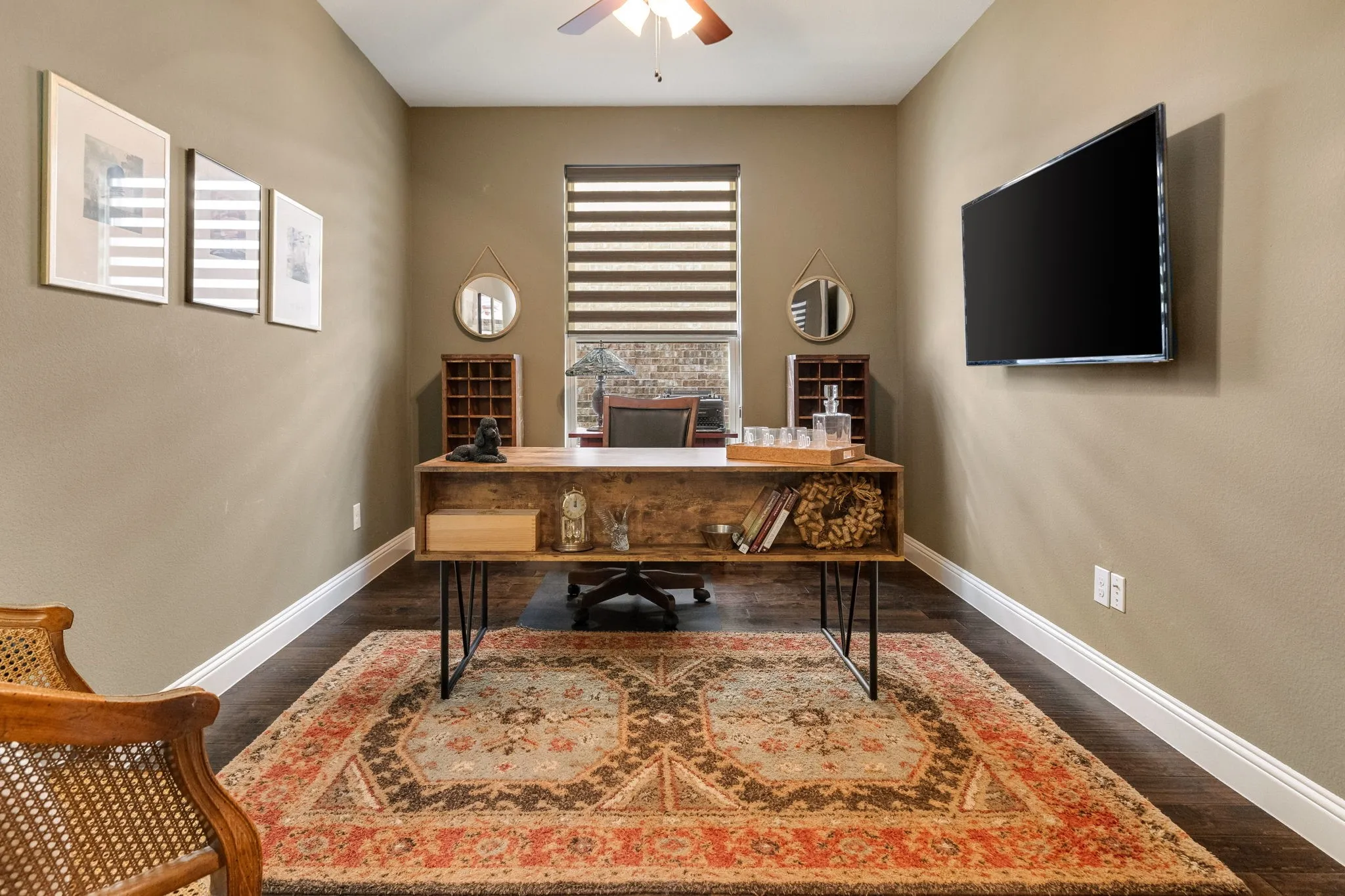 Dedicated office with ceiling fan and natural light.