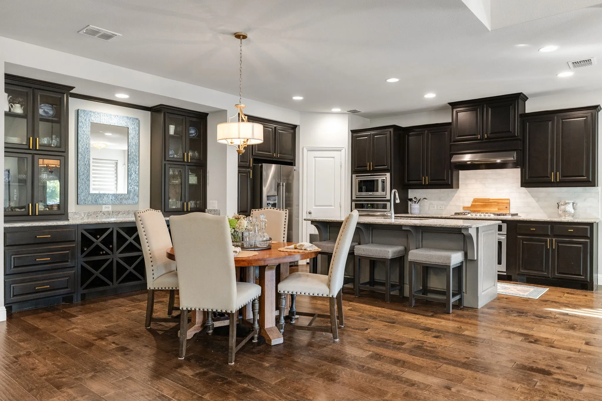Dining room features butler's pantry with built-in cabinetry and wine storage.