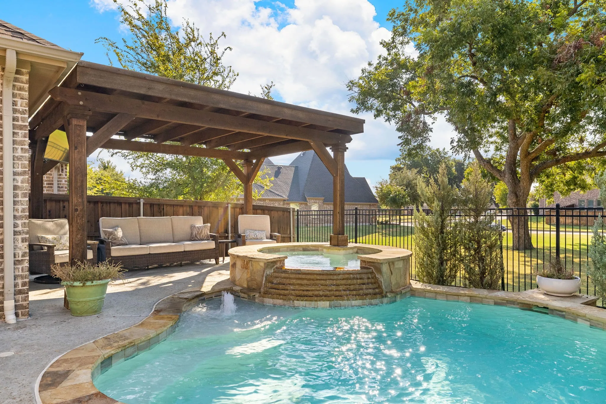 Sparkling pool with hot tub and water features.