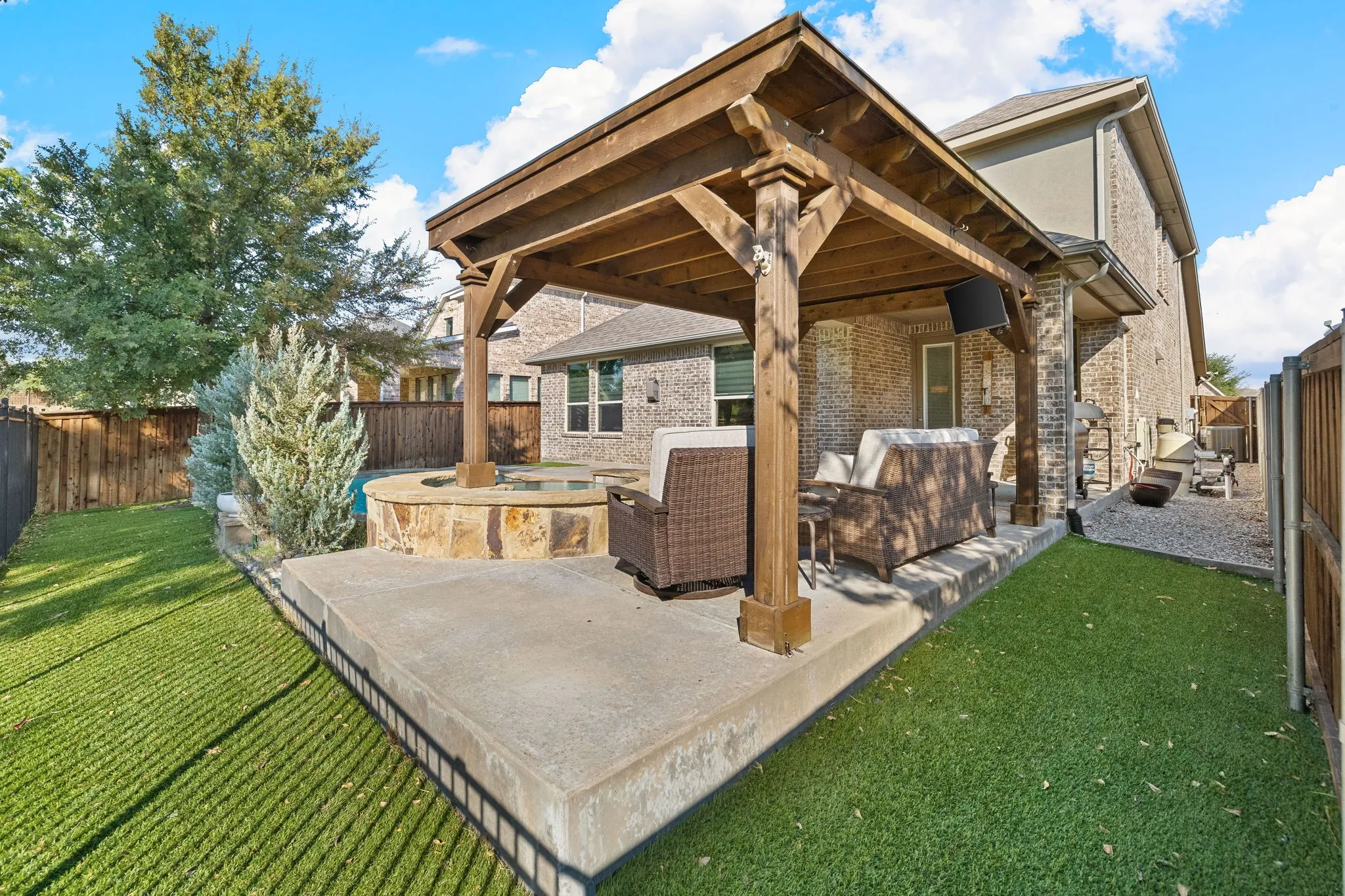 Grassy yard surrounded in privacy fencing.
