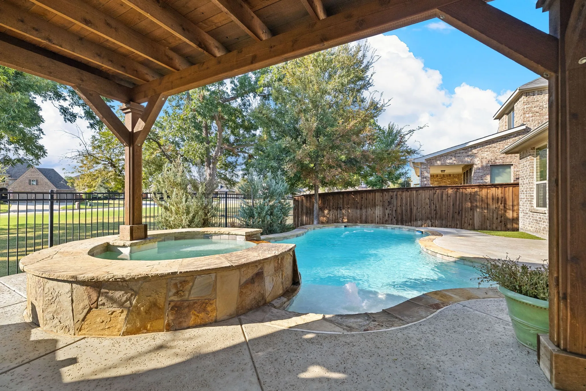 Pergola covered patio overlooking the pool and spa.