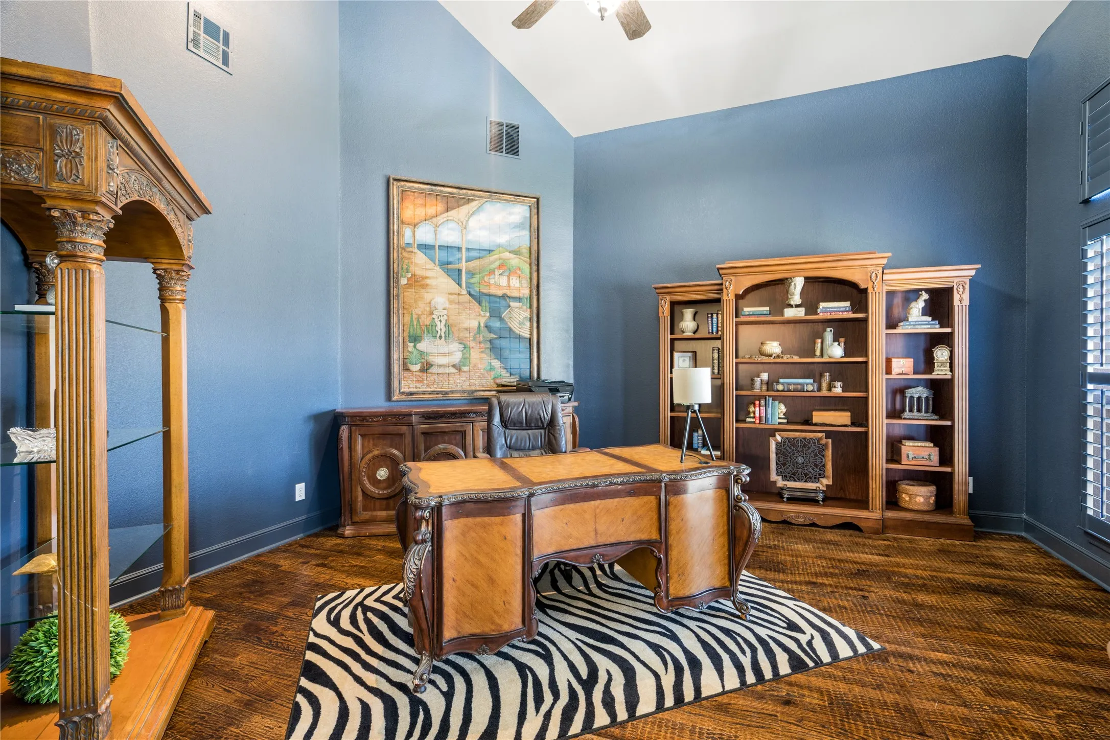 Vaulted ceiling and dark hardwood floors in this beautiful private office.