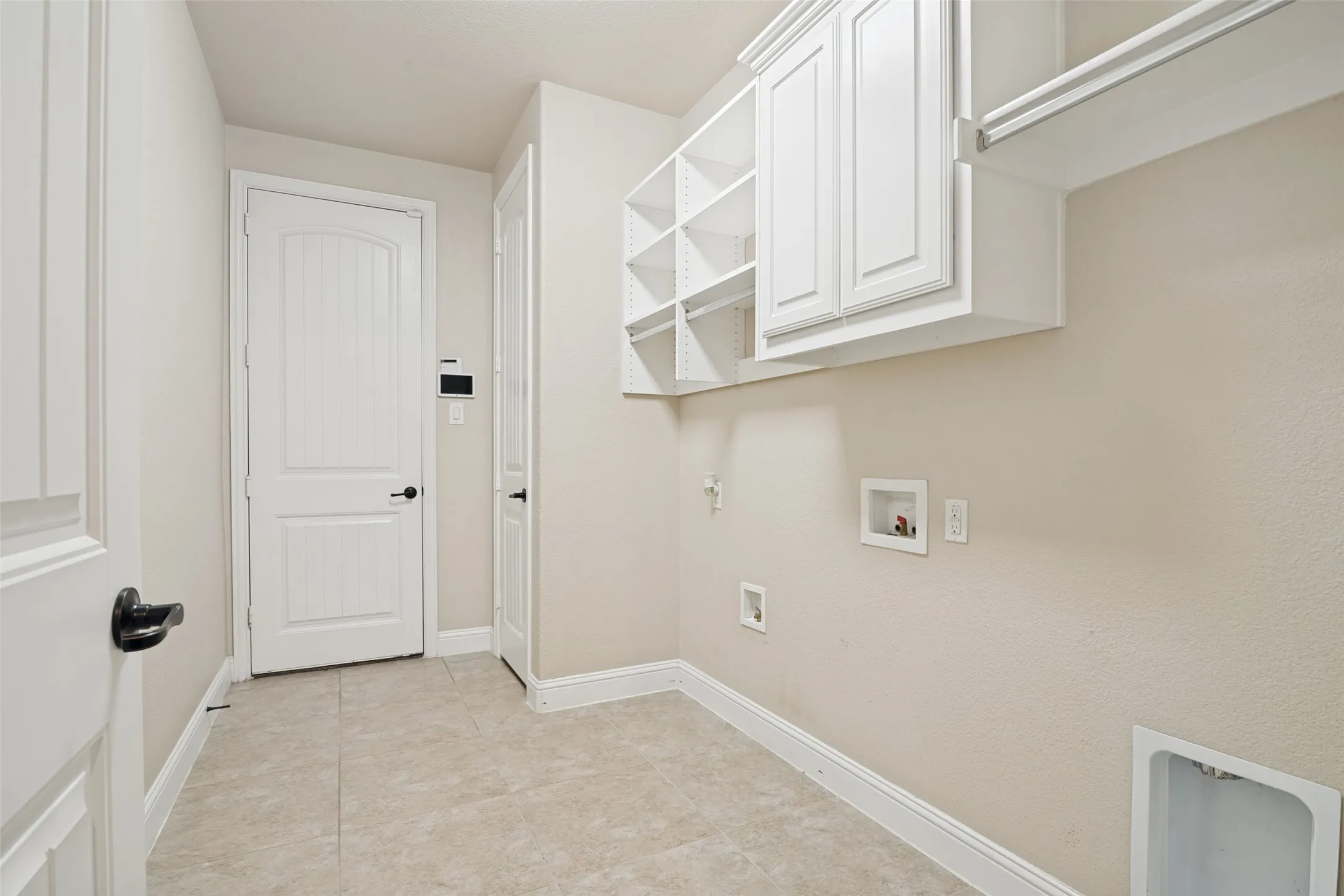Oversized laundry room off kitchen with access to one of two garages.
