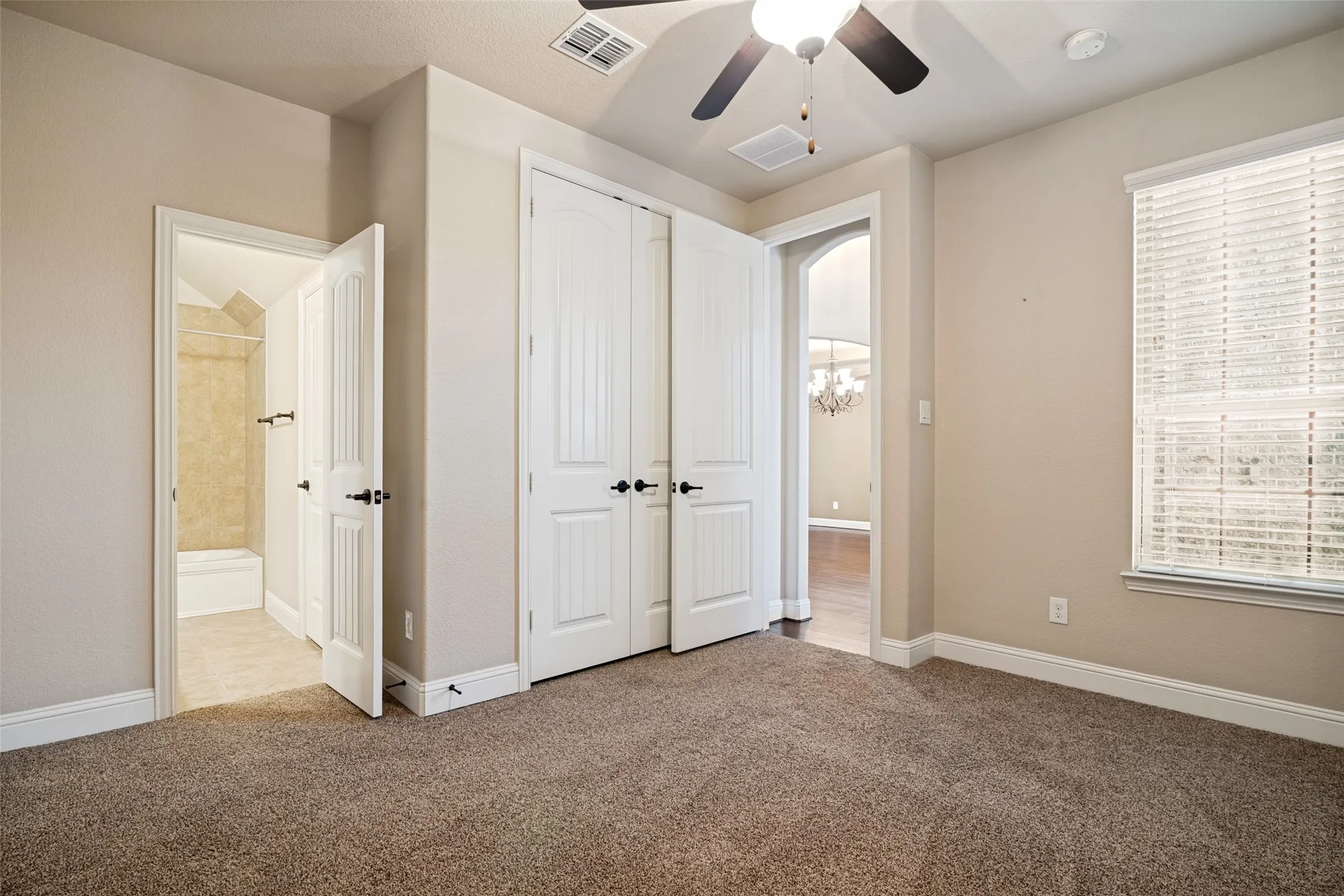 First-floor secondary bedroom off main entrance hall. Custom closet system.