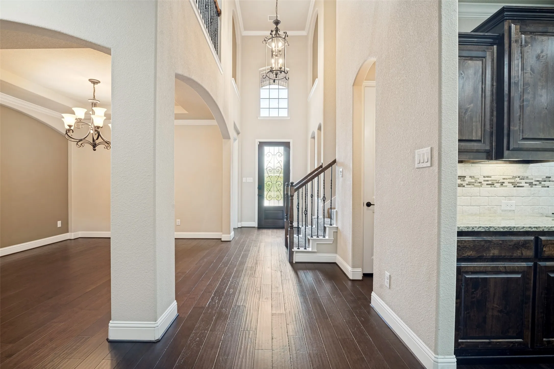 Entry hall facing metal and glass front door.