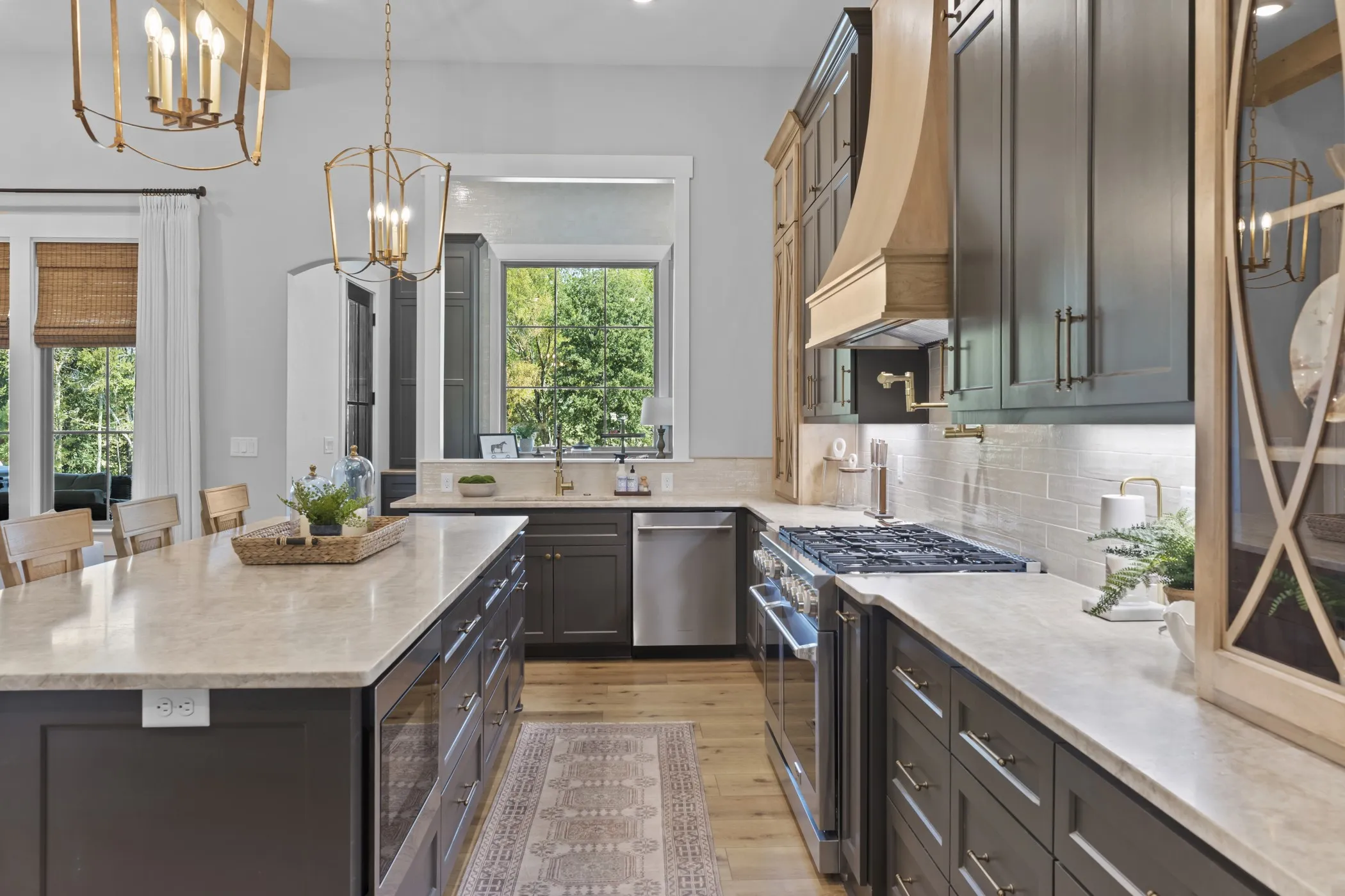 Expansive kitchen island with built-in storage, light-toned countertops, and wood-finish flooring