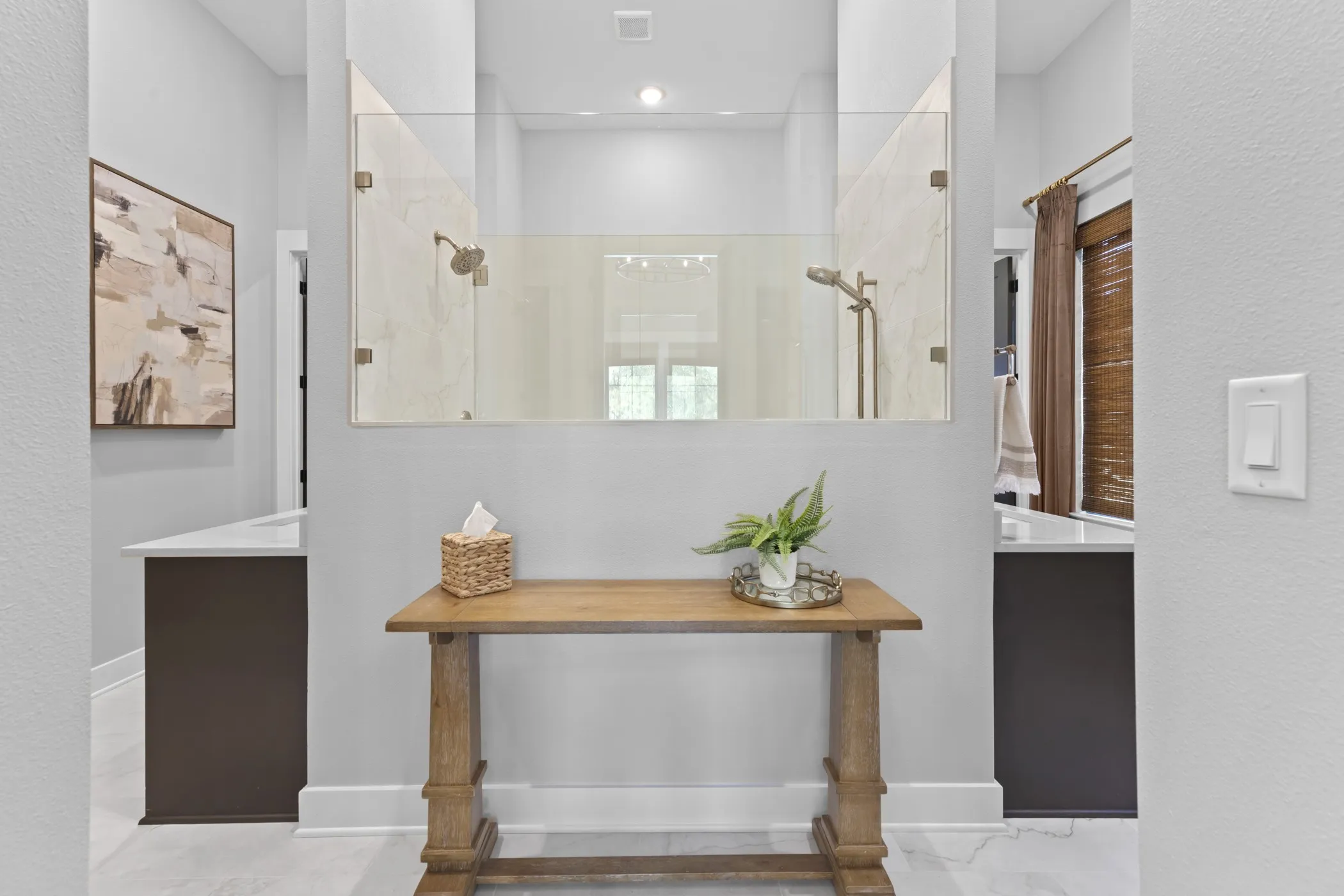 Dual walk-in shower with glass enclosure, two separate vanities with white countertops, and wood-finish flooring