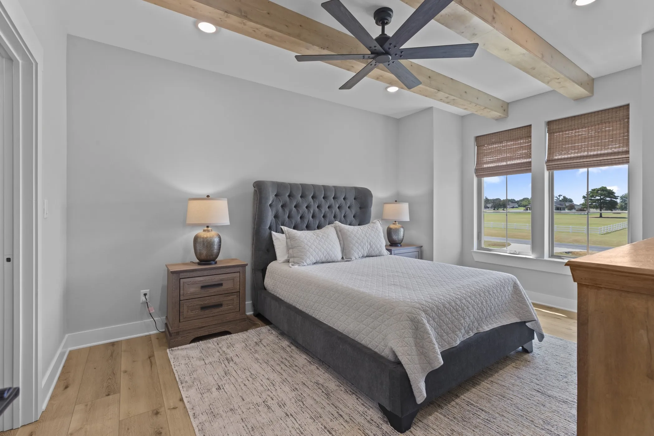 Wood-finish flooring with a neutral area rug