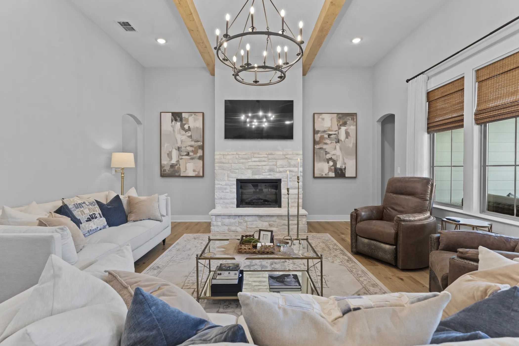 Sophisticated living room anchored by a linear fireplace with stacked stone surround and built-in shelving