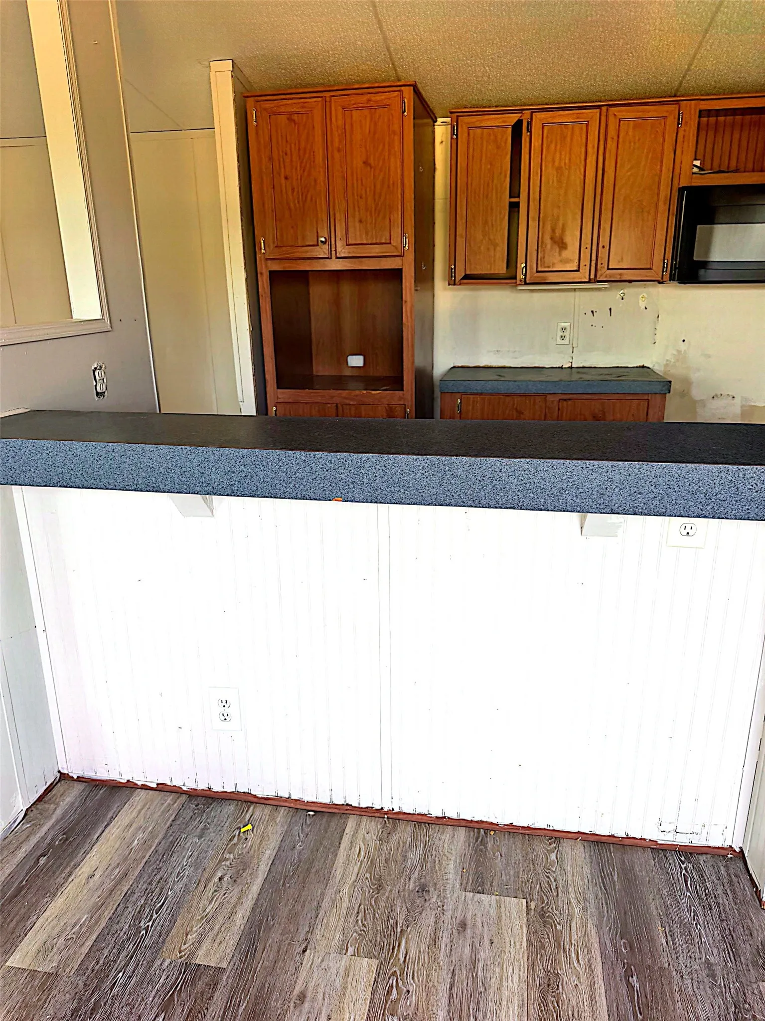 Wood-finish flooring, wood cabinetry, and a built-in microwave